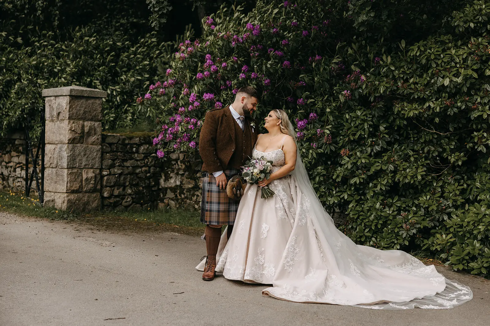 Bride wearing Norvinia by Sottero and Midgley smiling at her husband