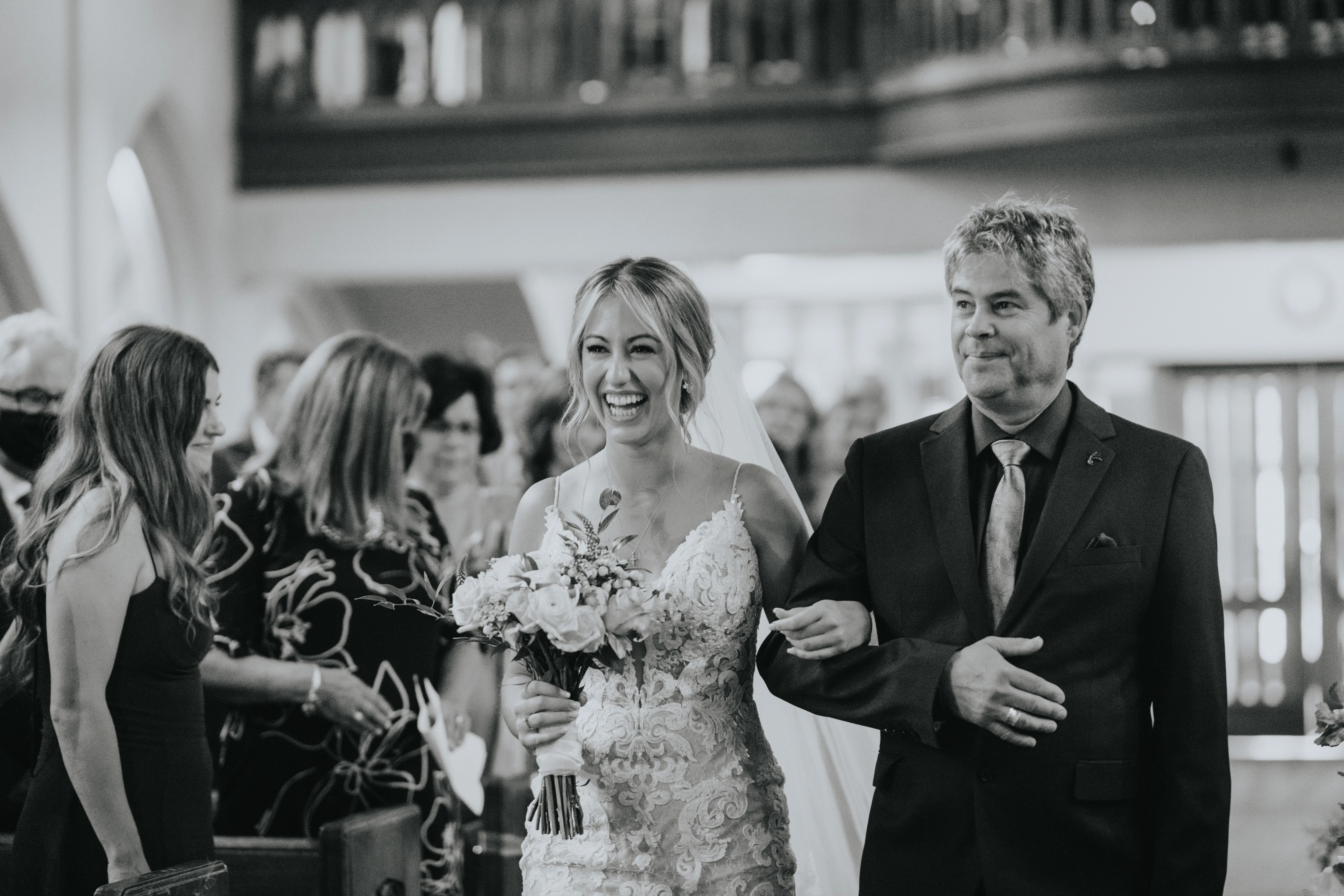 Bride with father wearing a romantic lace sheath wedding dress.