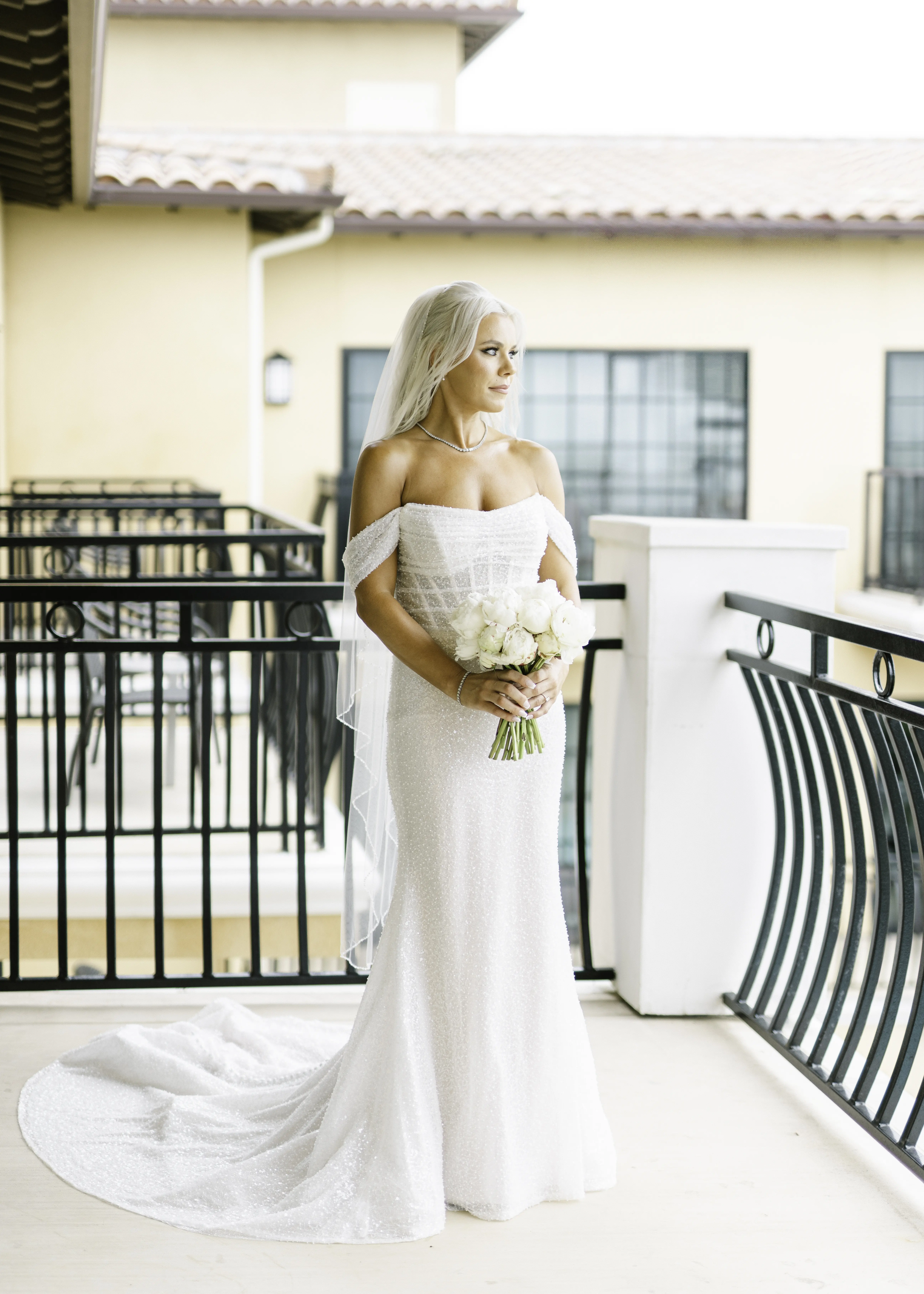 Bride Wearing Pearl Sparkly Bridal Gown Called Drew By Maggie Sottero On A Balcony