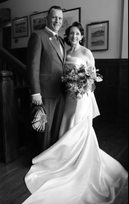 Bride Wearing Classic Simple Wedding Dress Called Mitchell By Maggie Sottero With The Groom