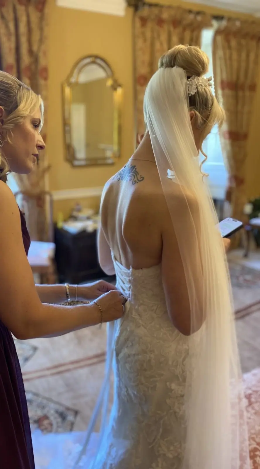 Bride wearing Helen by Rebecca Ingram being laced up