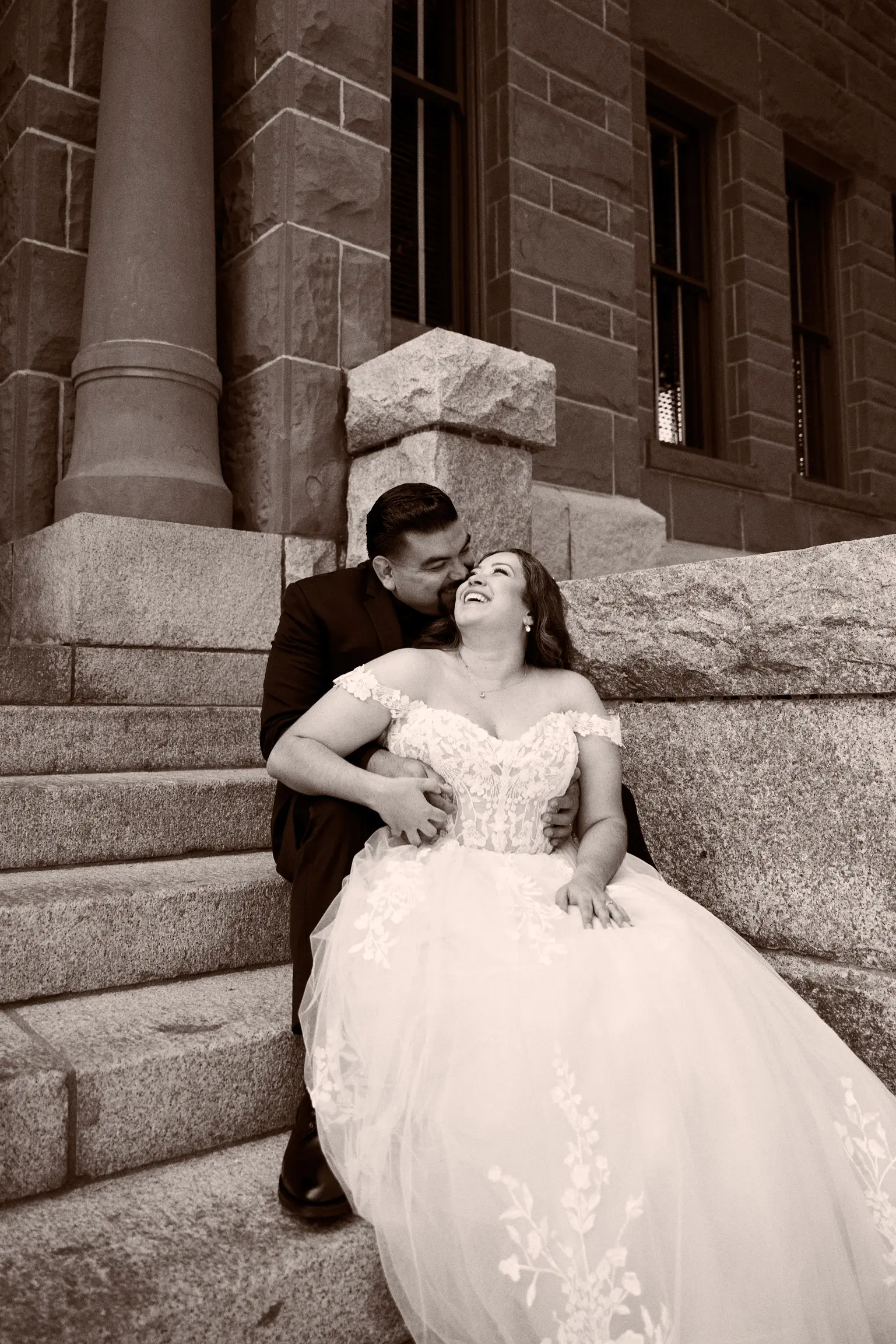 Bride Wearing Lace Ballgown Wedding Dress Called Harlem By Maggie Sottero Sitting On Grooms Lap