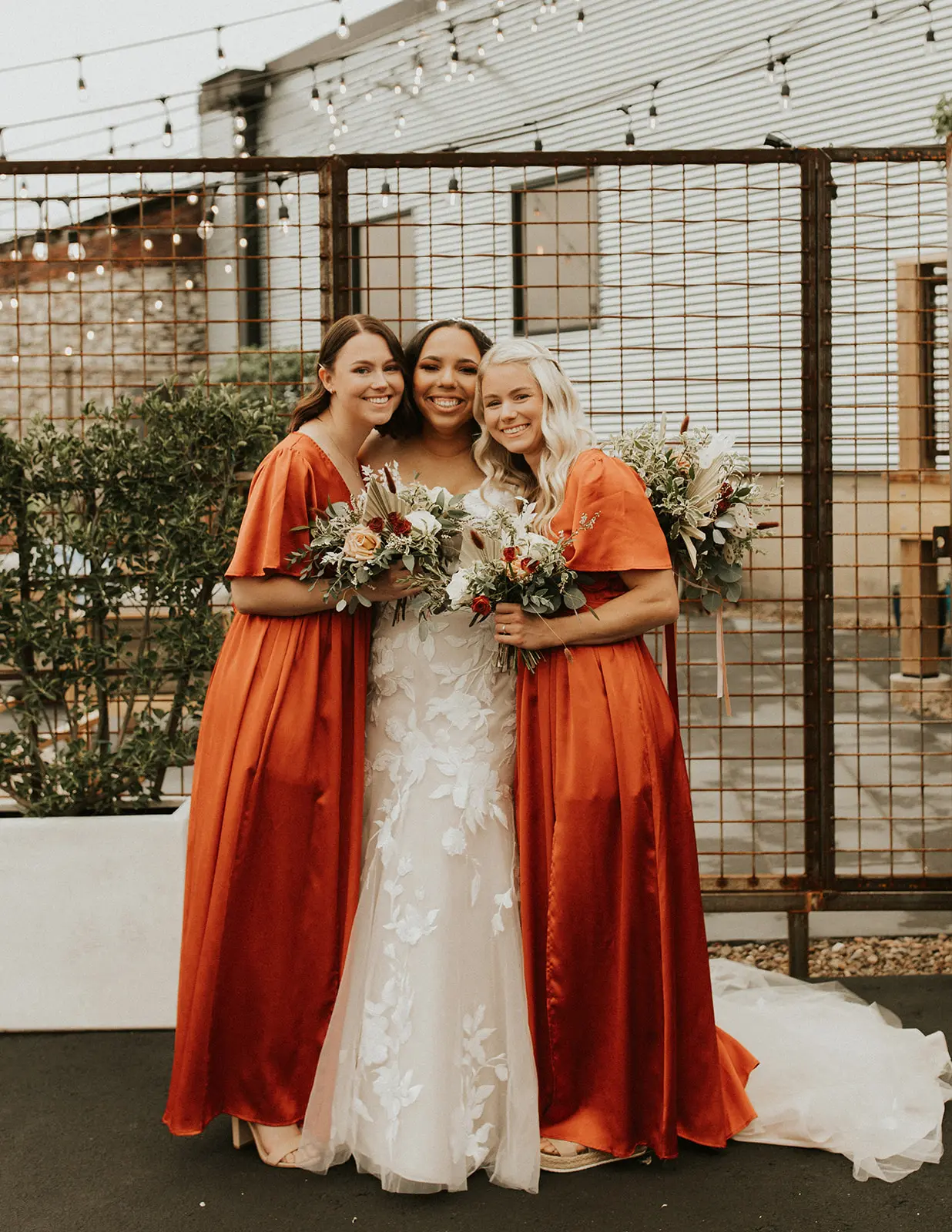 Bride Standing With Bridesmaids Wearing Wedding Dress Called Hattie by Rebecca Ingram