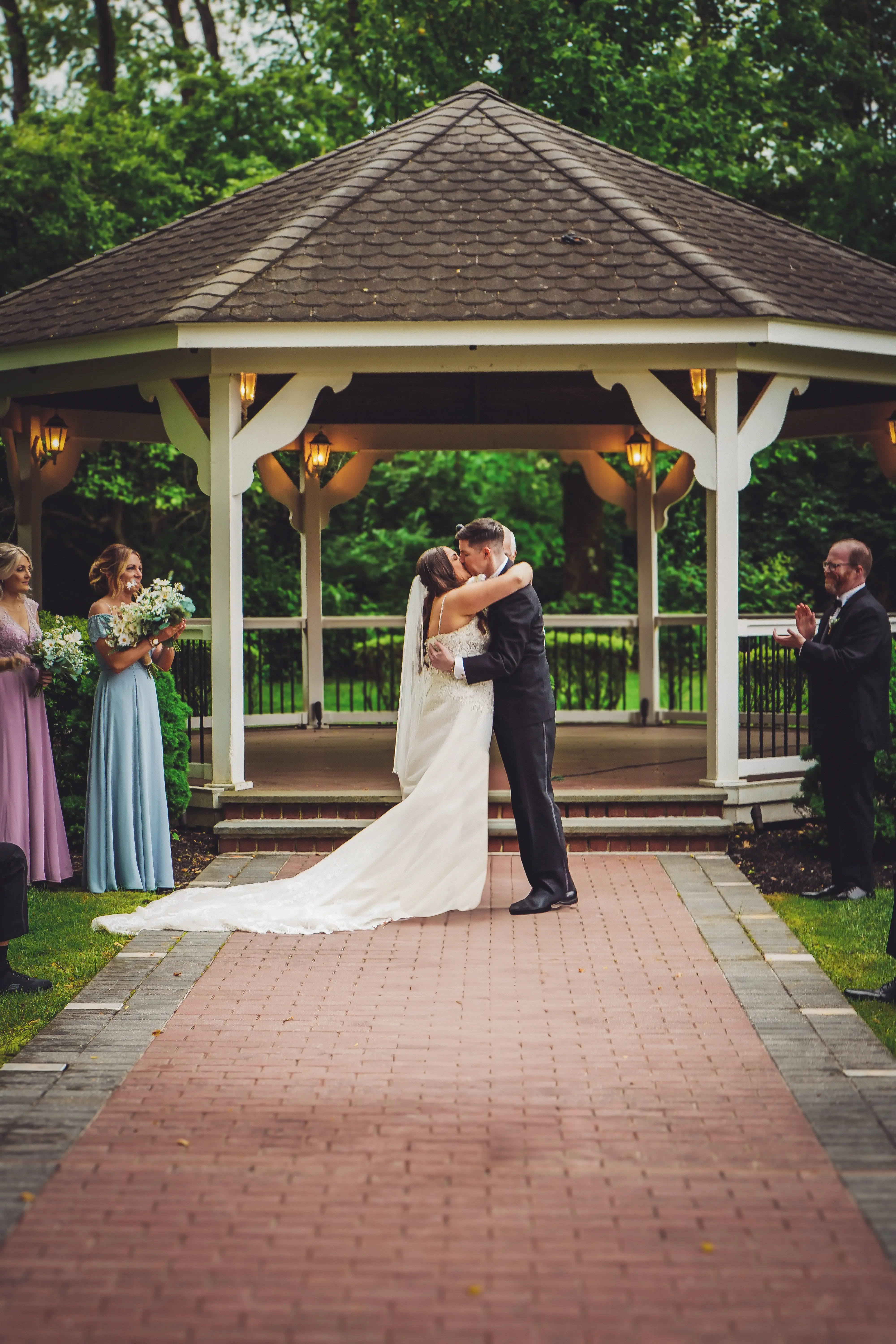 Bride wearing Fiona by Maggie Sottero kissing her husband at their ceremony