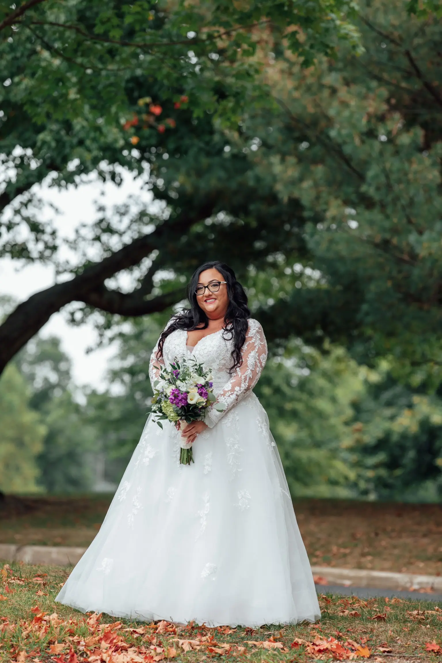 Bride Wearing Vintage Royalty Long Sleeve Wedding Dress Called Raphael By Maggie Sottero Holding Bouquet Outside