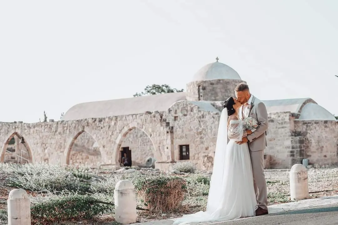 Bride Wearing Boho A-Line Wedding Dress Called Nerida By Sottero And Midgley Kissing Groom