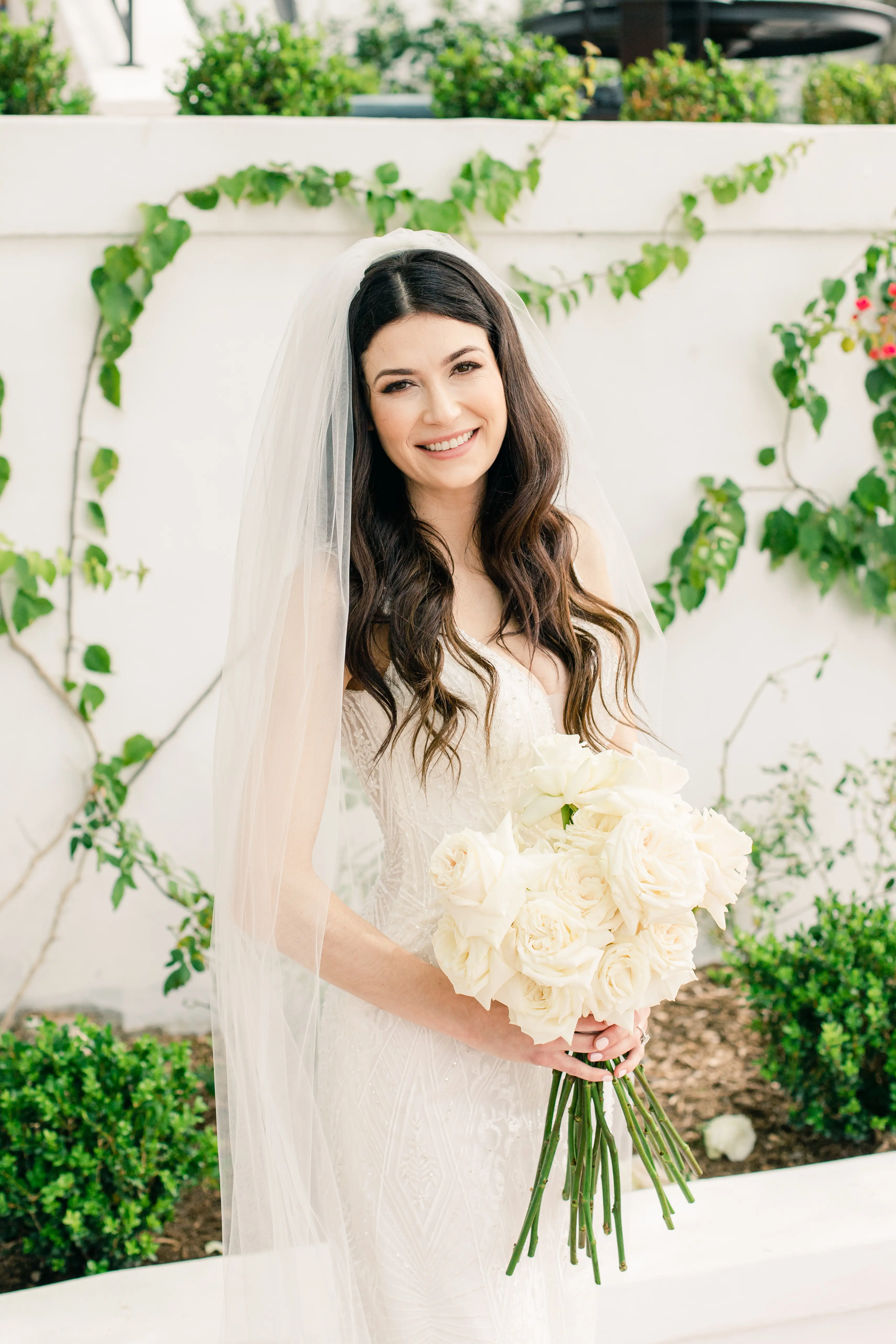 Bride Wearing Vintage Art Deco Wedding Dress Called Elaine By Maggie Sottero Smiling With Flowers