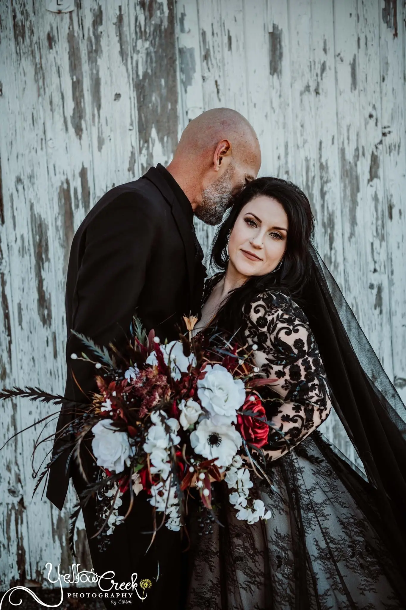 Bride And Groom Standing Together. Bride Wearing Chic Black Wedding Dress With Nature-Inspired Details Called Zander By Sottero And Midgley