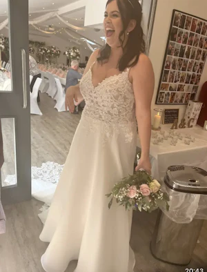 Bride Wearing Romantic Floral Wedding Dress With Lace Cutout Train Called Savannah By Maggie Sottero Holding Flower Bouquet