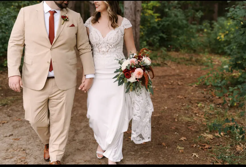 Bride Wearing Crepe Lace Wedding Dress Called Anson By Sottero And Midgley Holding Hands And Walking With Groom