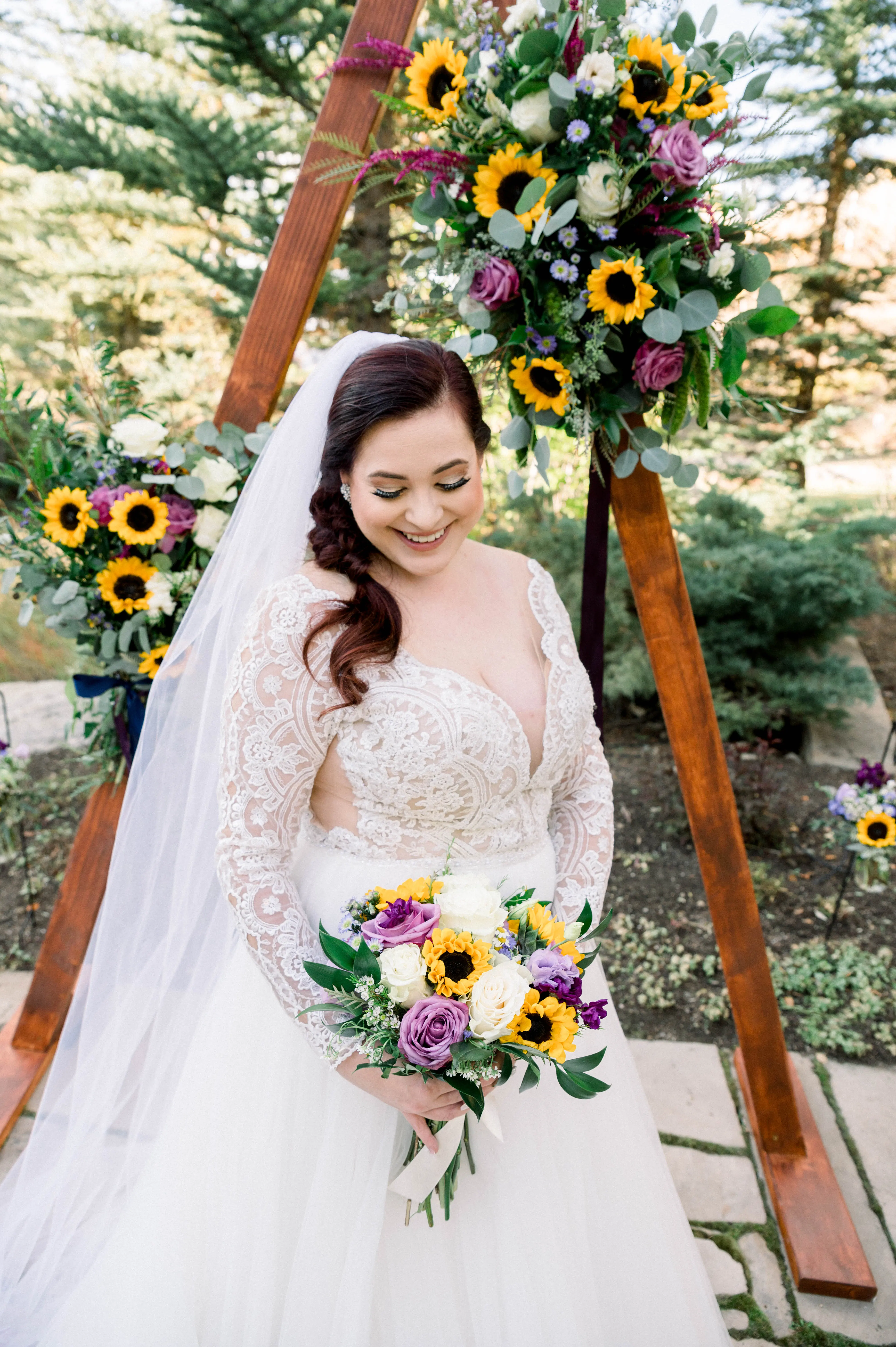 Bride Wearing Princess Wedding Dress Called Mallory Dawn By Maggie Sottero Holding a Yellow and Purple Bouquet