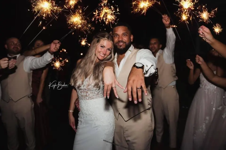 Bride with groom wearing sexy v back sheath wedding dress