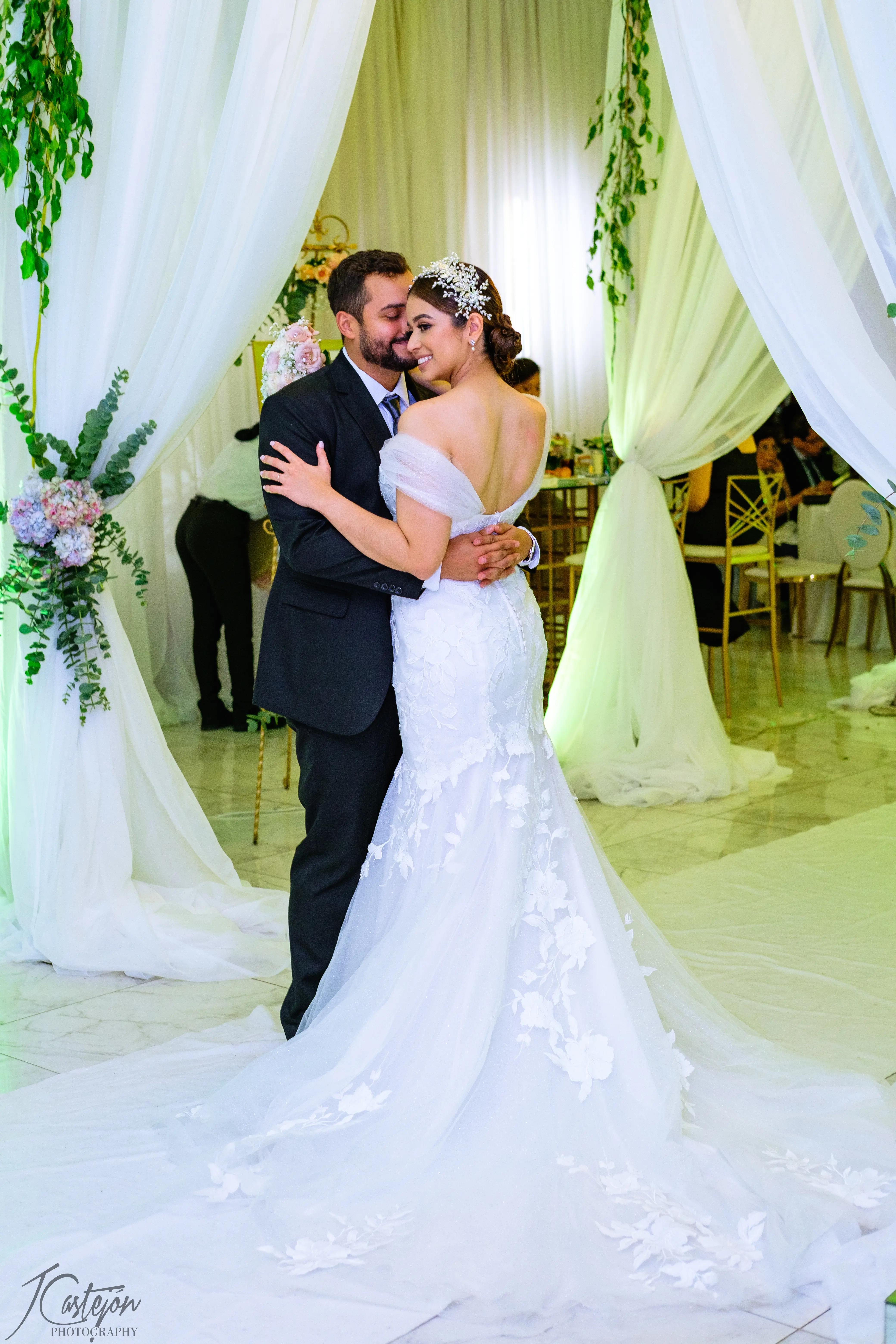 Groom Dancing with Bride at Floral Reception Wearing Wedding Dress Called Hattie by Rebecca Ingram