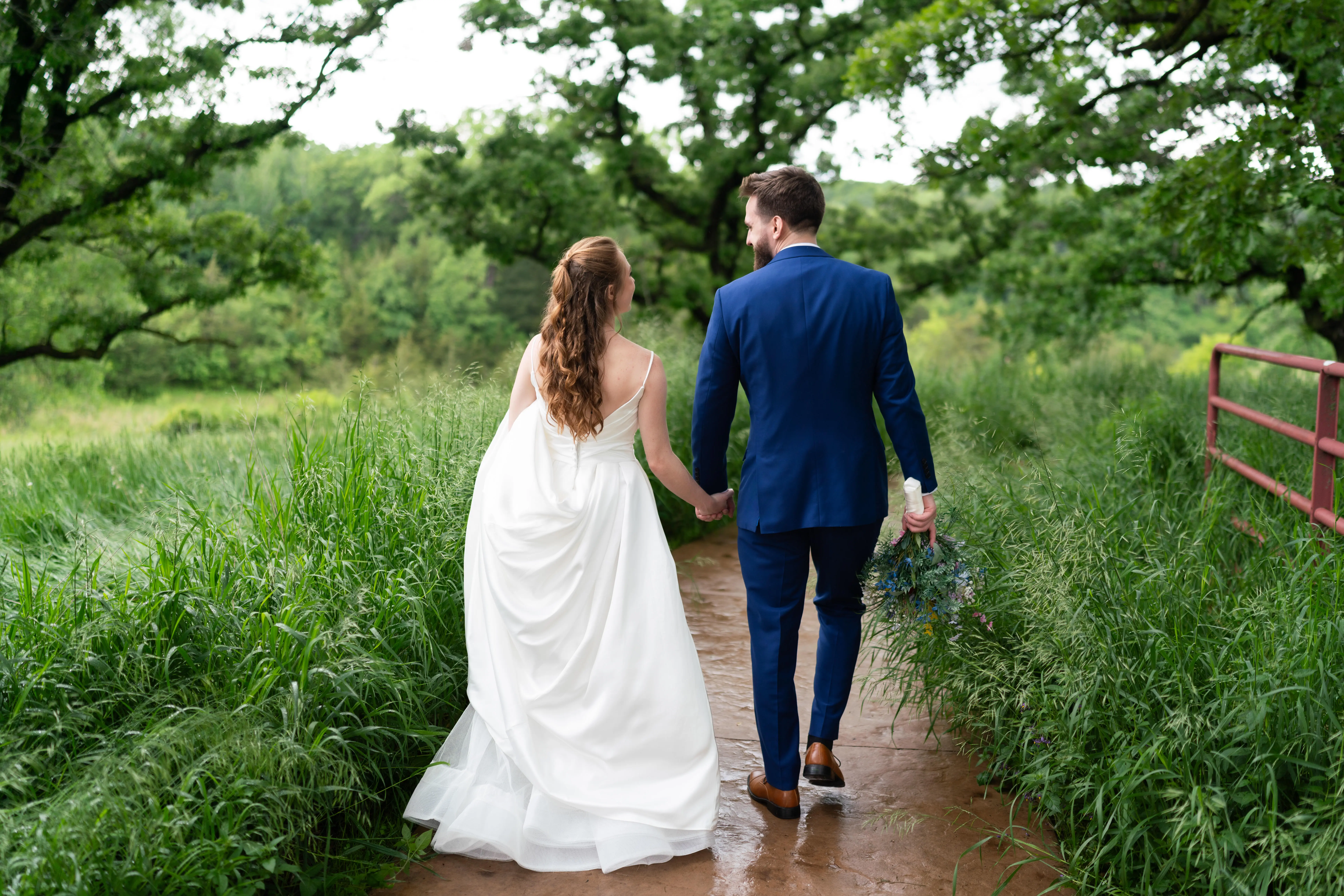 Bride wearing Scarlet by Maggie Sottero walking with her husband