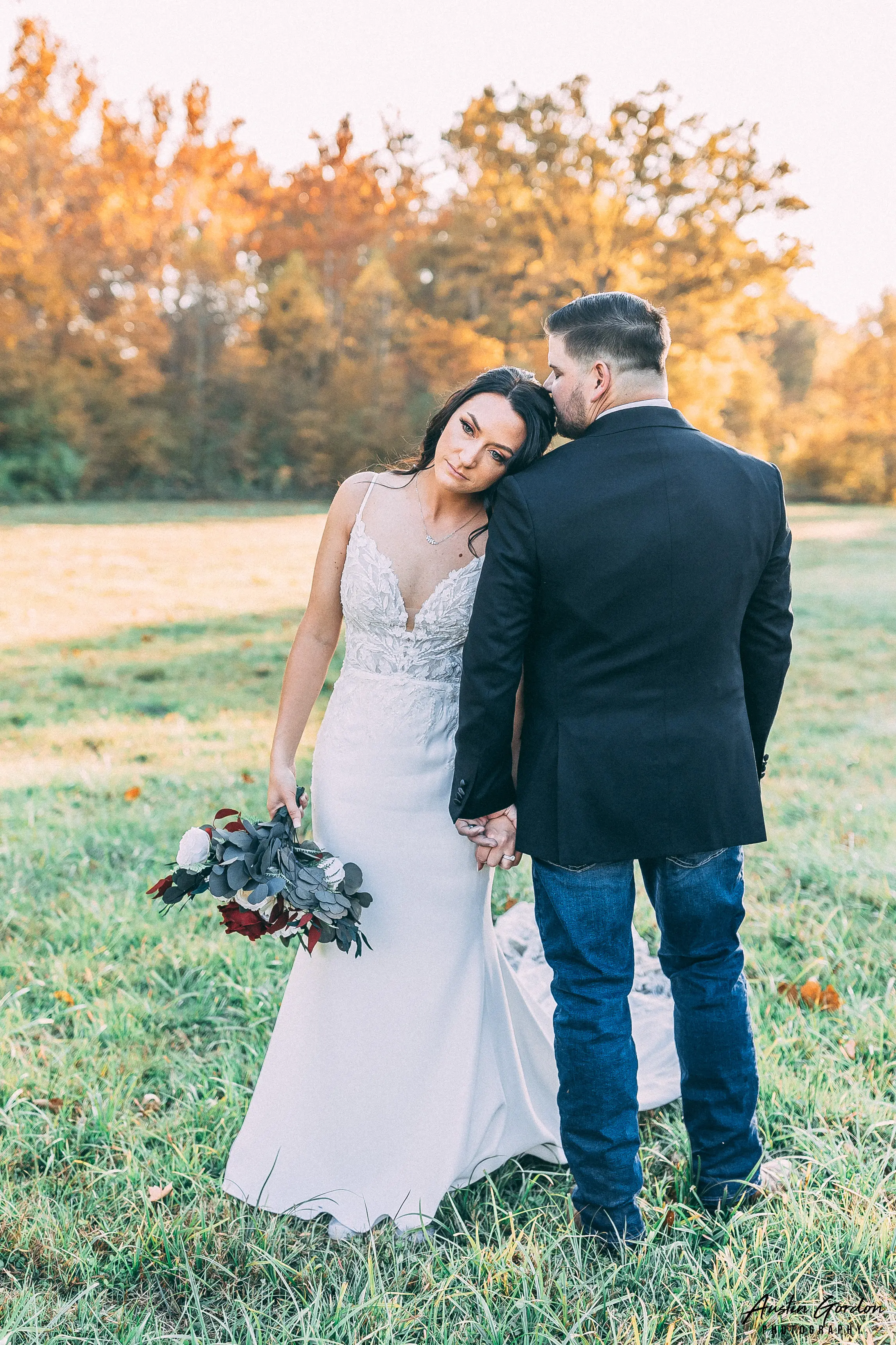 Bride Wearing Crepe Sheath Wedding Dress Called Alda By Rebecca Ingram Leaning On Groom