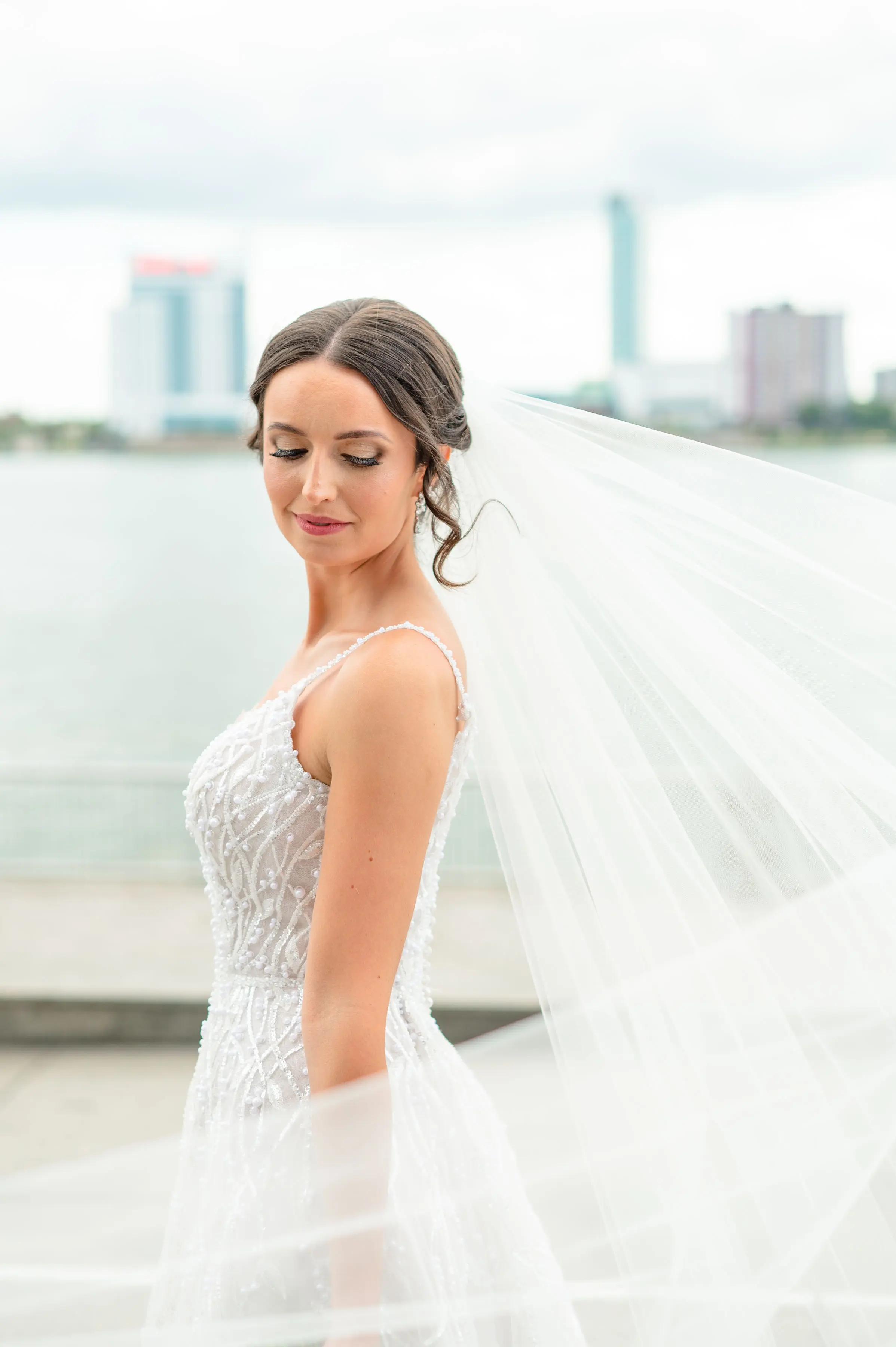 Bride wearing Marvine wedding gown by Sottero and Midgley