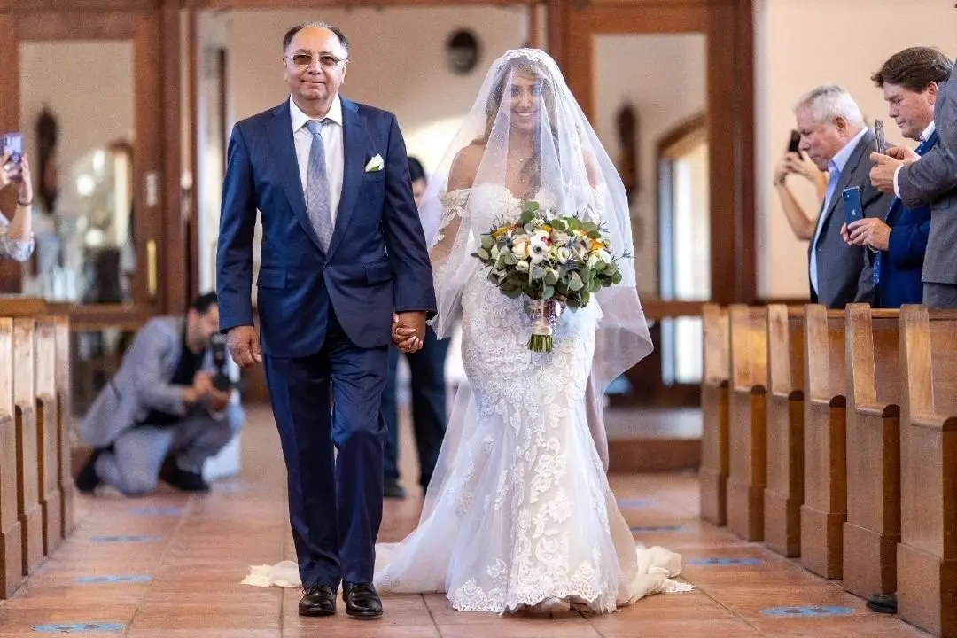 Bride Wearing Sparkly Fit-And-Flare Wedding Dress Called Fiona By Maggie Sottero Walking Down The Aisle