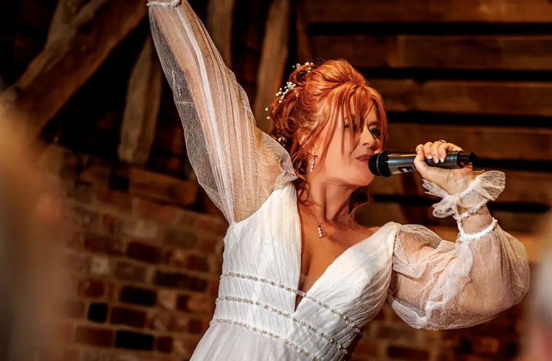 Real Bride in Bishop Sleeve A-Line Wedding Gown Called Joanne by Rebecca Ingram