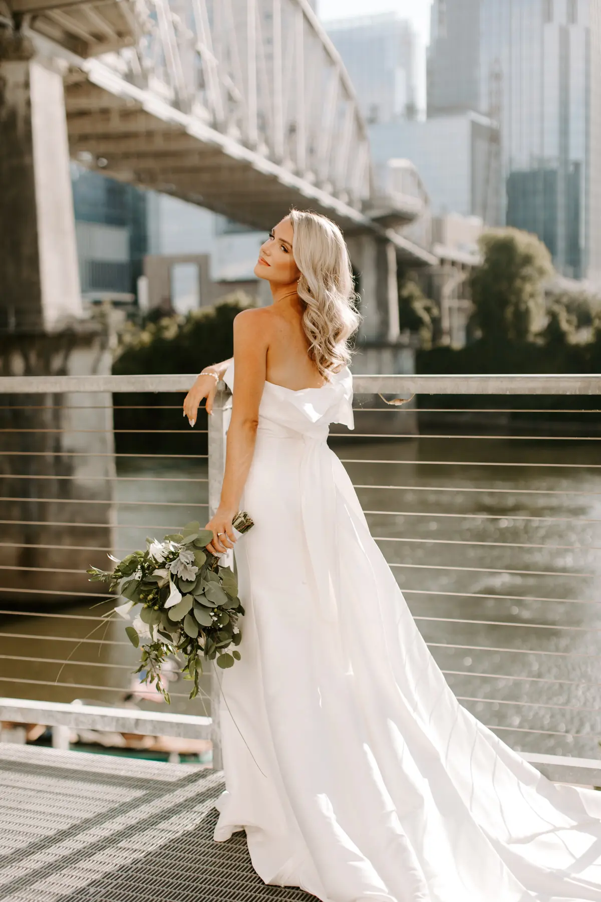 Bride Wearing Unique Strapless Wedding Dress With Beautiful Back Bow Mitchell By Maggie Sottero