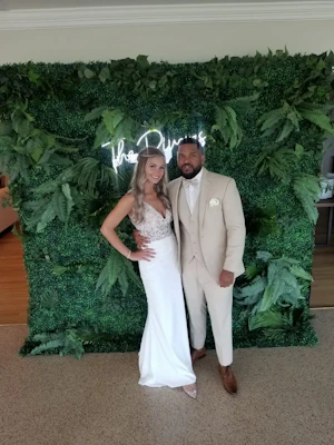 Bride with groom wearing sexy v back sheath wedding dress