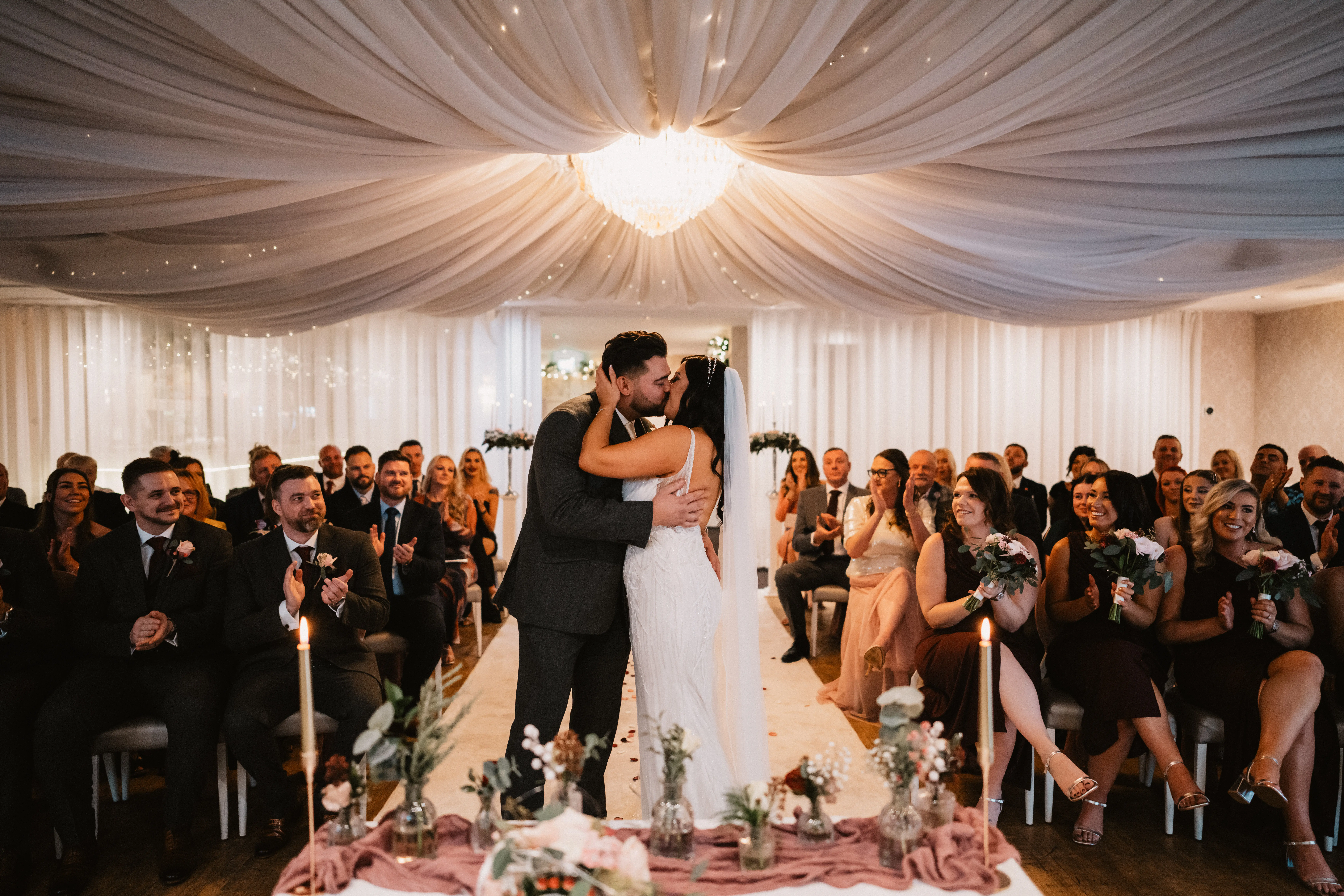Bride Wearing Art Deco Wedding Dress Called Luella By Sottero And Midgley Kissing Groom At Ceremony