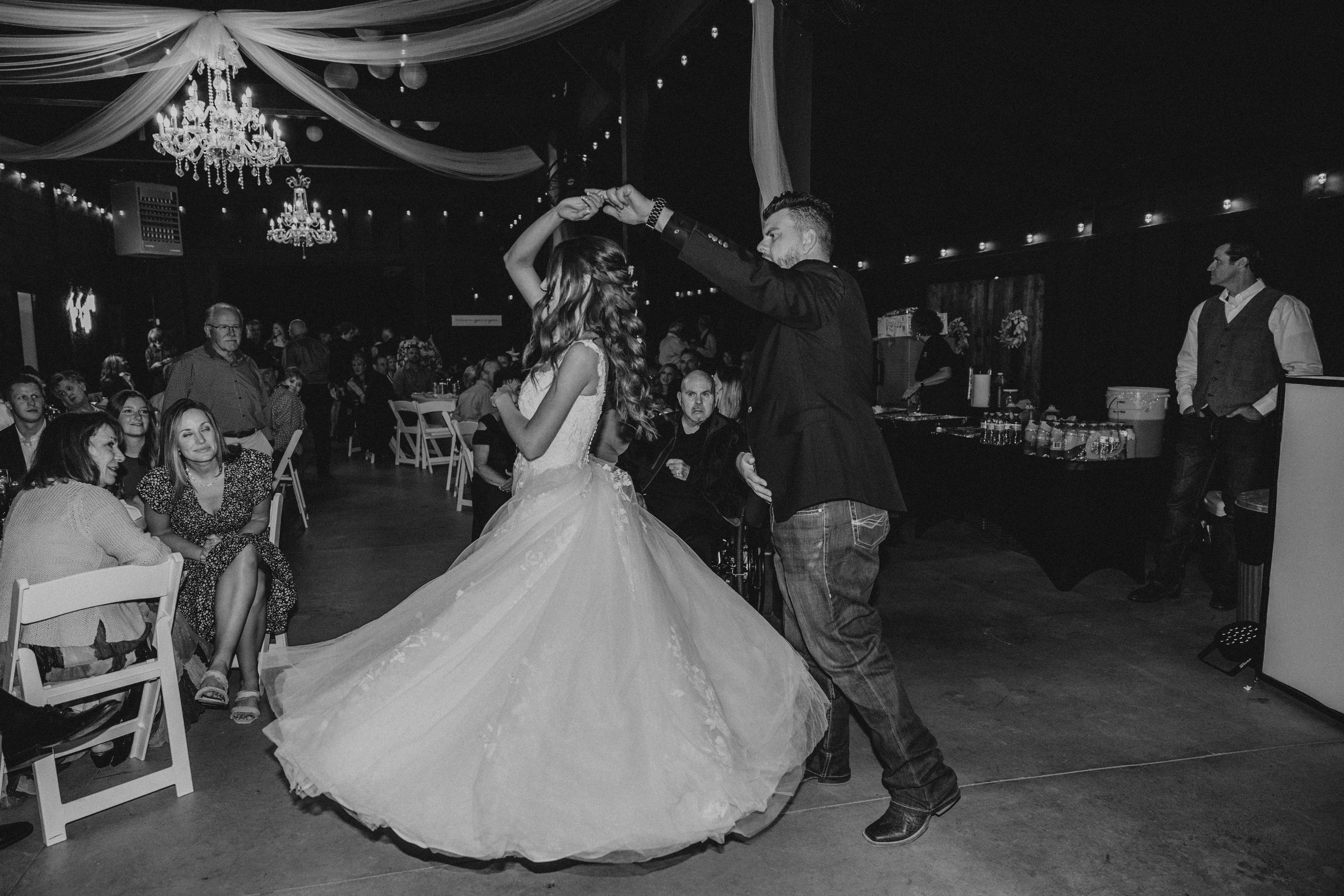 Bride wearing Harlem wedding dress by Maggie Sottero dancing with her husband