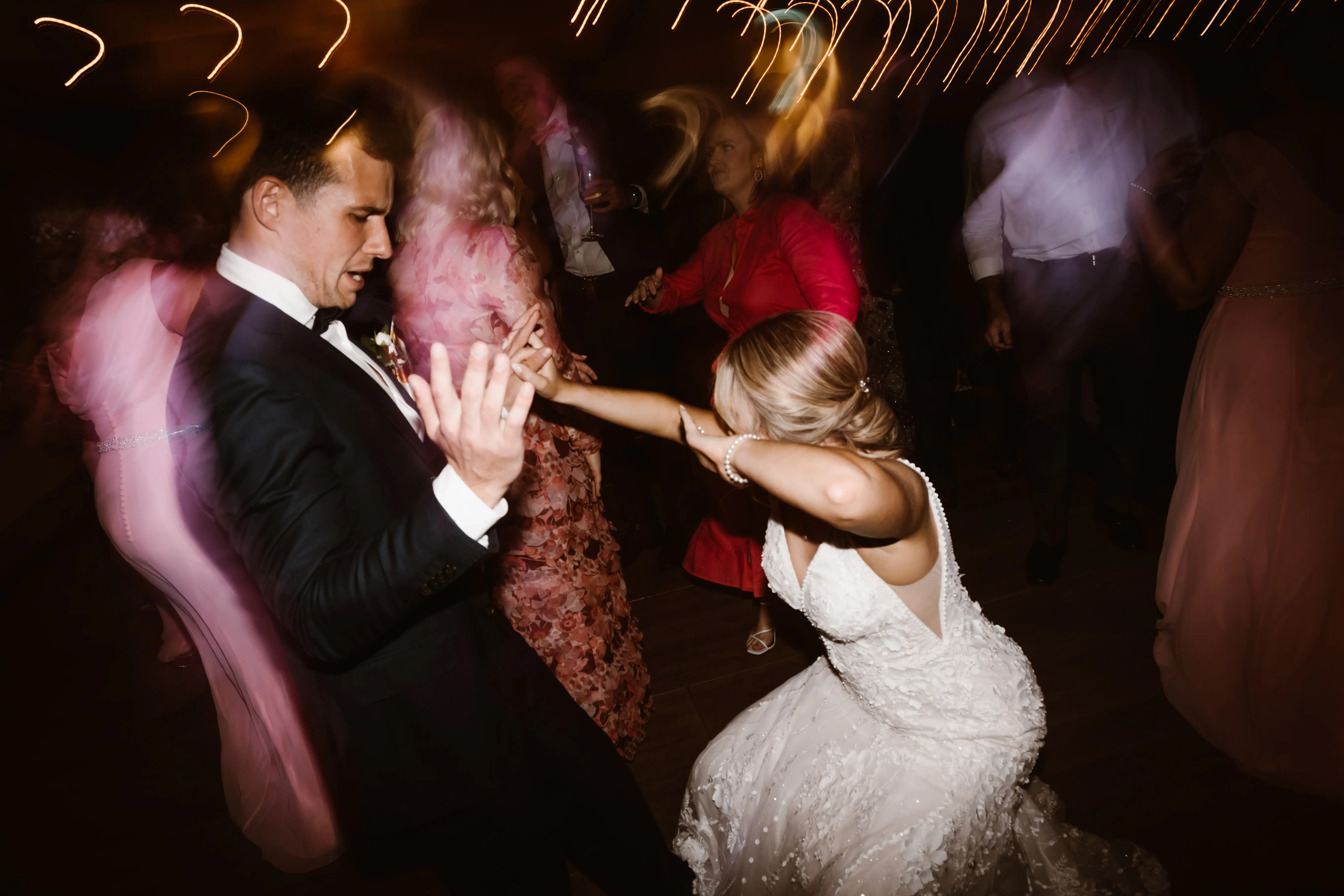 Groom Dancing with Bride in Vintage Inspired Puff Sleeve Mermaid Wedding Dress in 3-D Floral Motifs Called Cruz by Sottero & Midgley