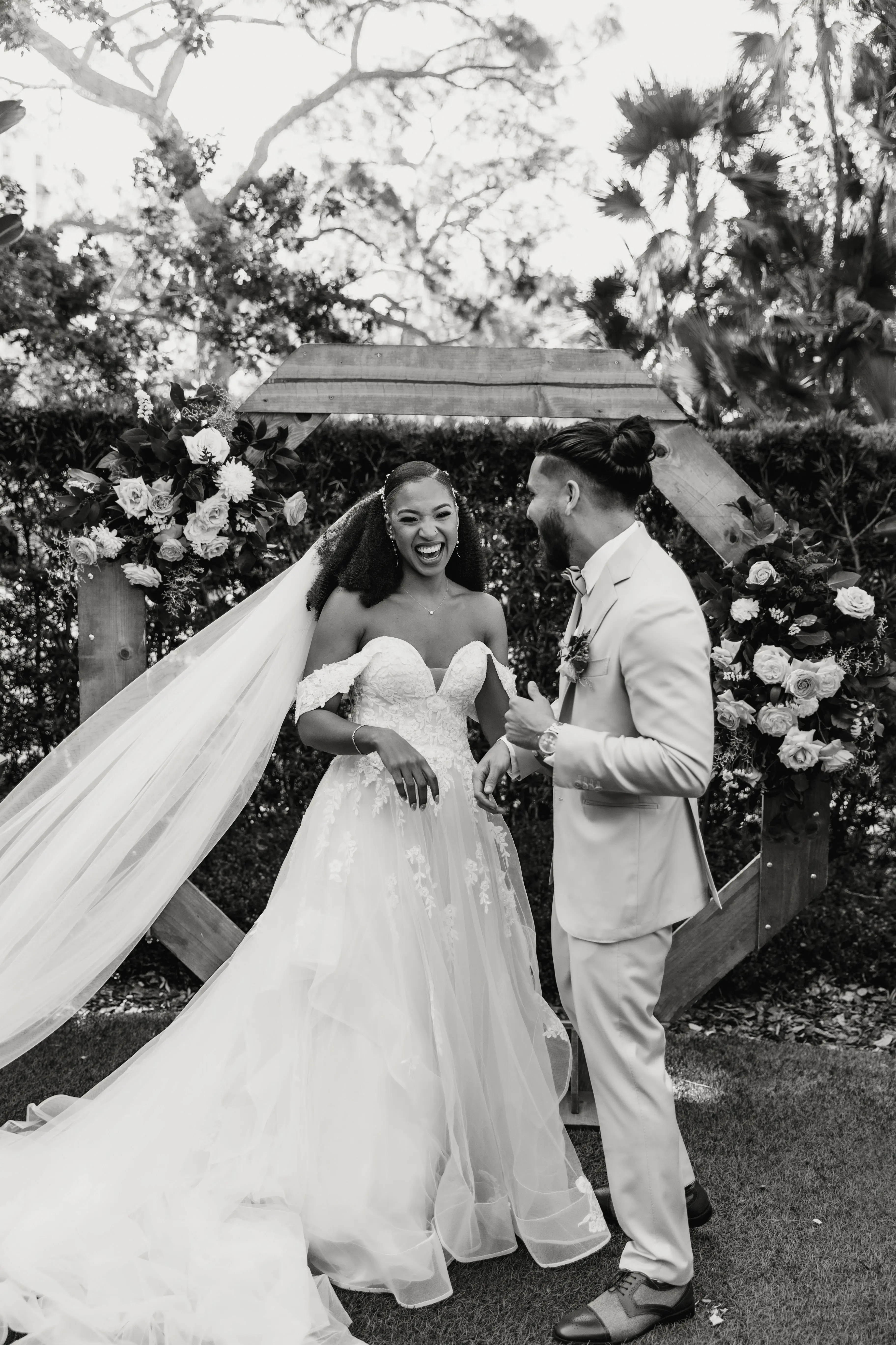Bride wearing Lettie by Rebecca Ingram laughing with her husband