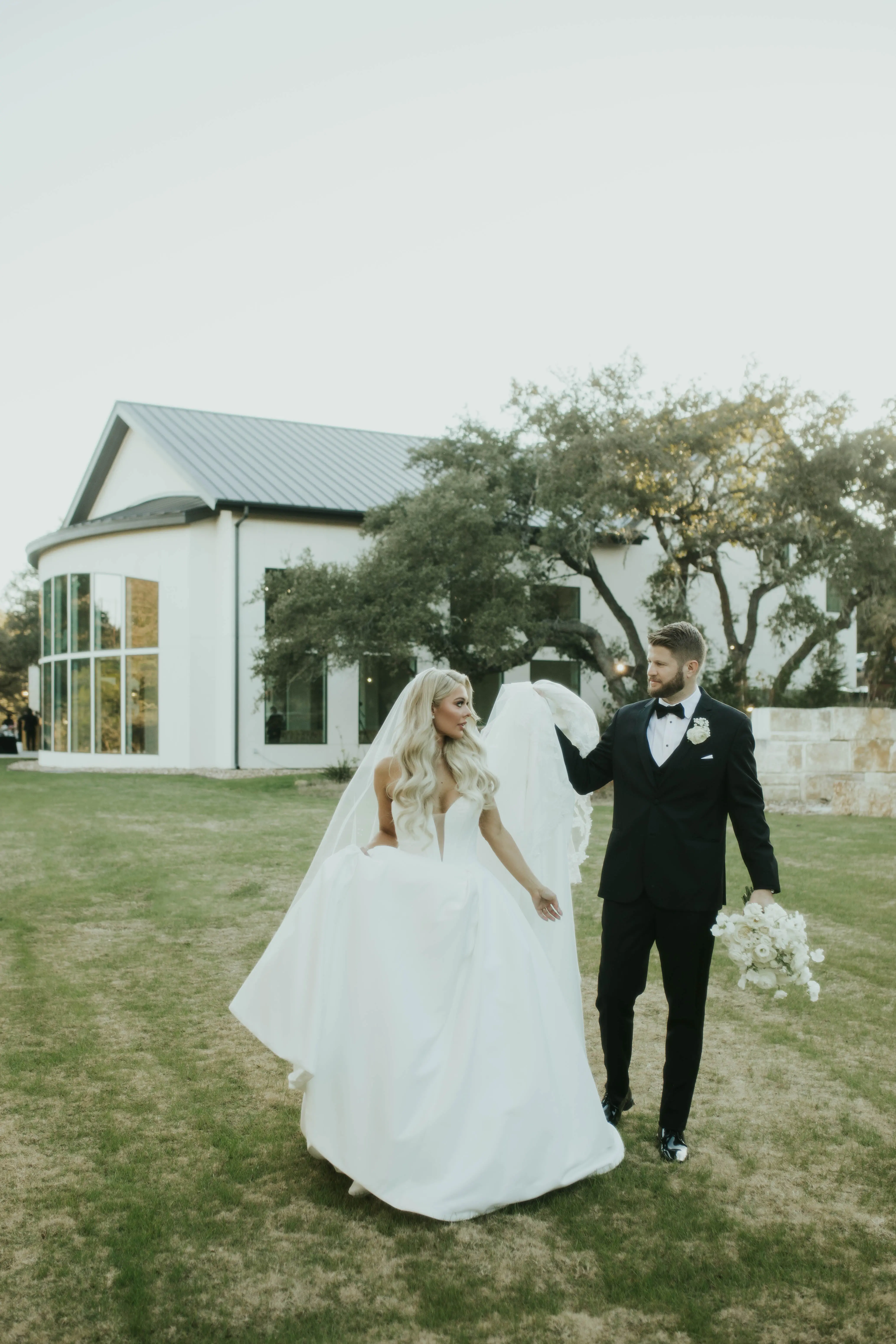 Bride wearing Derrick by Maggie Sottero walking with her husband