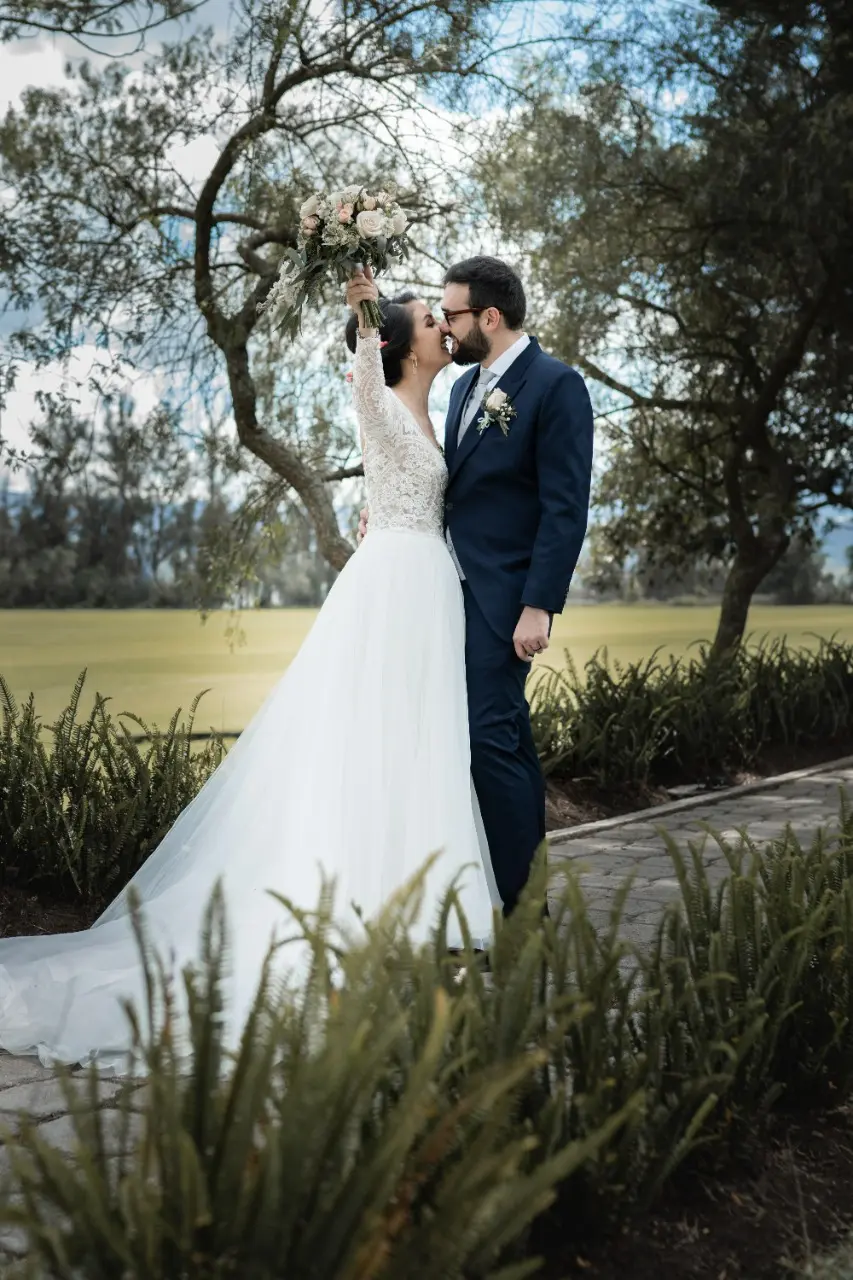 Bride in Long Sleeve Ball Gown Wedding Dress Named Mallory Dawn by Maggie Sottero with Groom