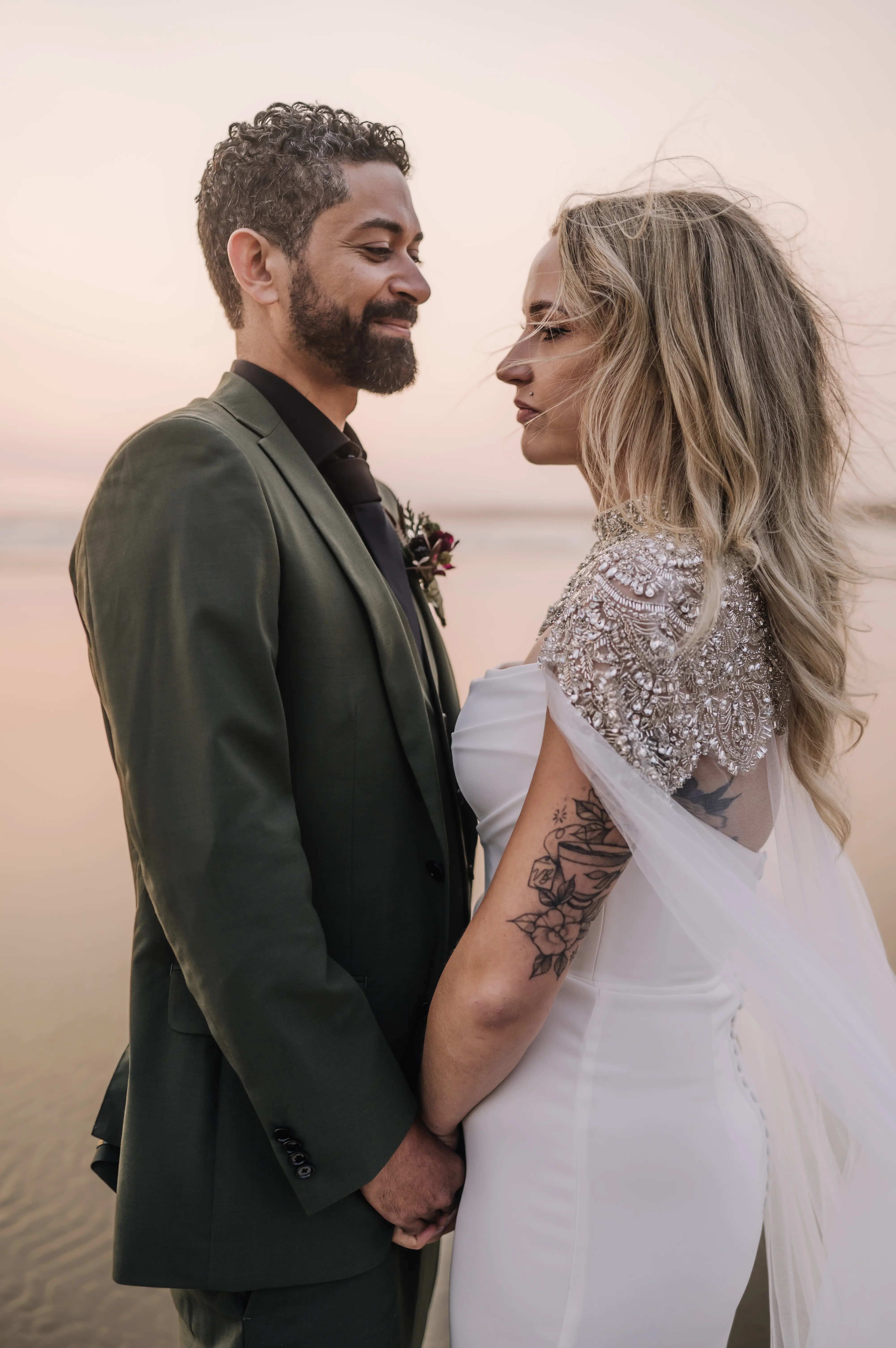 Bride wearing Summer wedding dress by Maggie Sottero holding hands with the groom