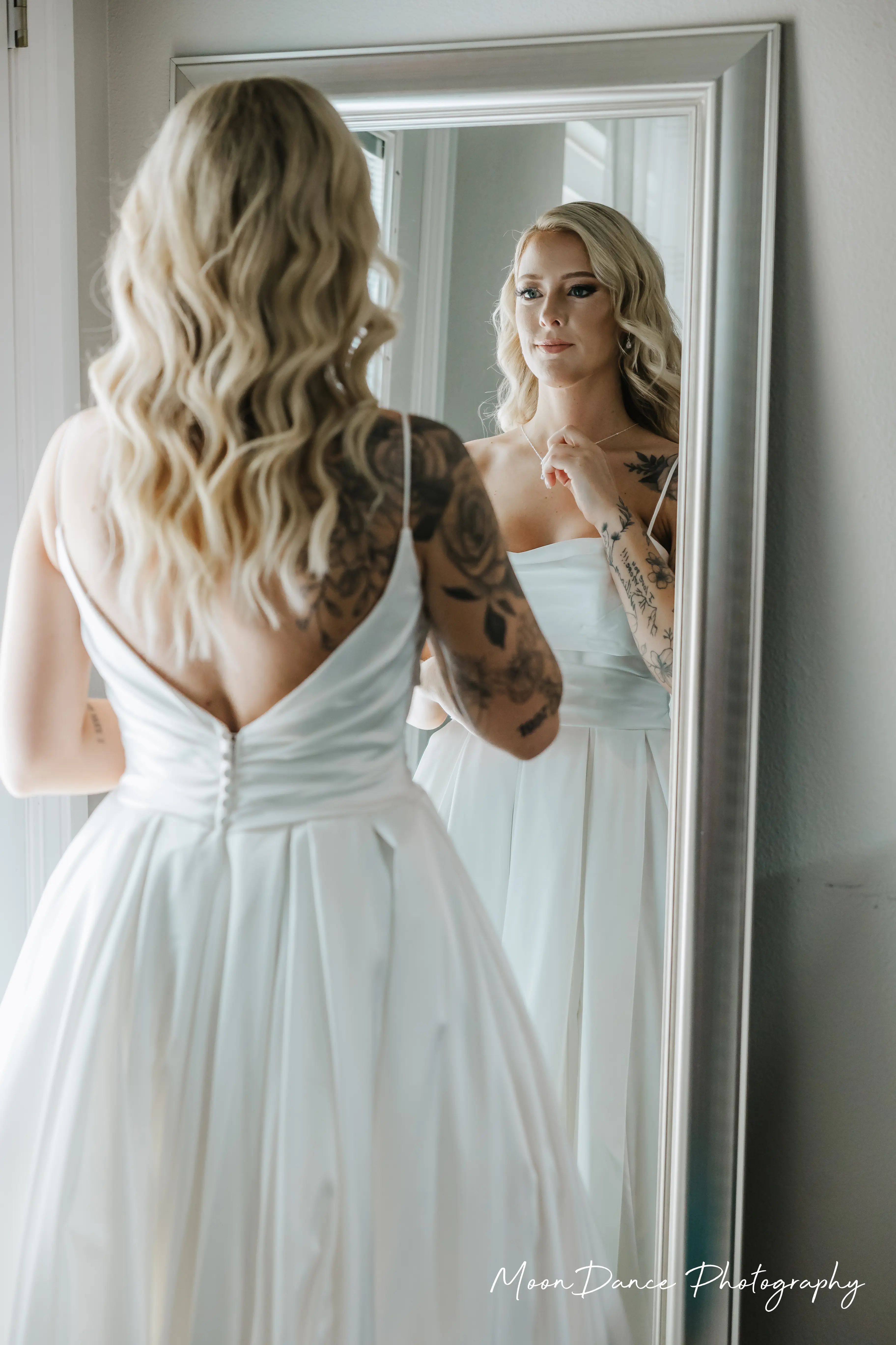 Bride Wearing Aline Satin Wedding Gown Called Scarlet By Maggie Sottero Looking In A Mirror