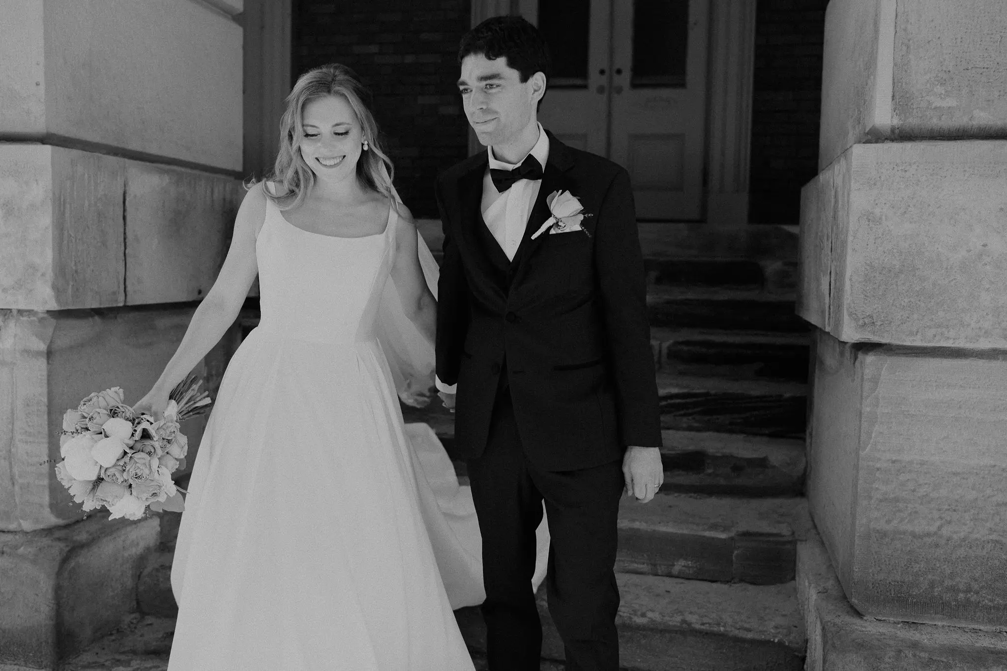 Bride wearing Selena wedding gown by Maggie Sottero walking with her husband