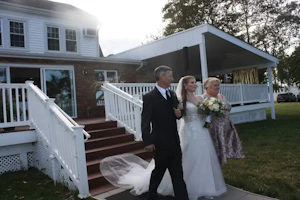 Bride Wearing Princess Wedding Dress With Long Sleeves Called Stevie By Maggie Sottero With Dad And Mom In Front Of House