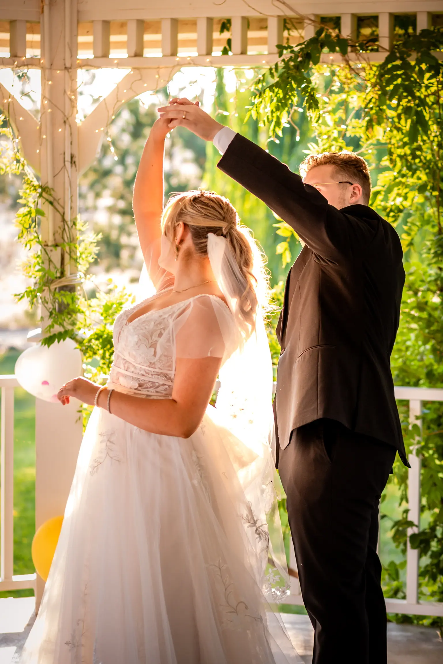 Bride wearing romantic lace A-line dress called Raelynn by Rebecca Ingram with groom