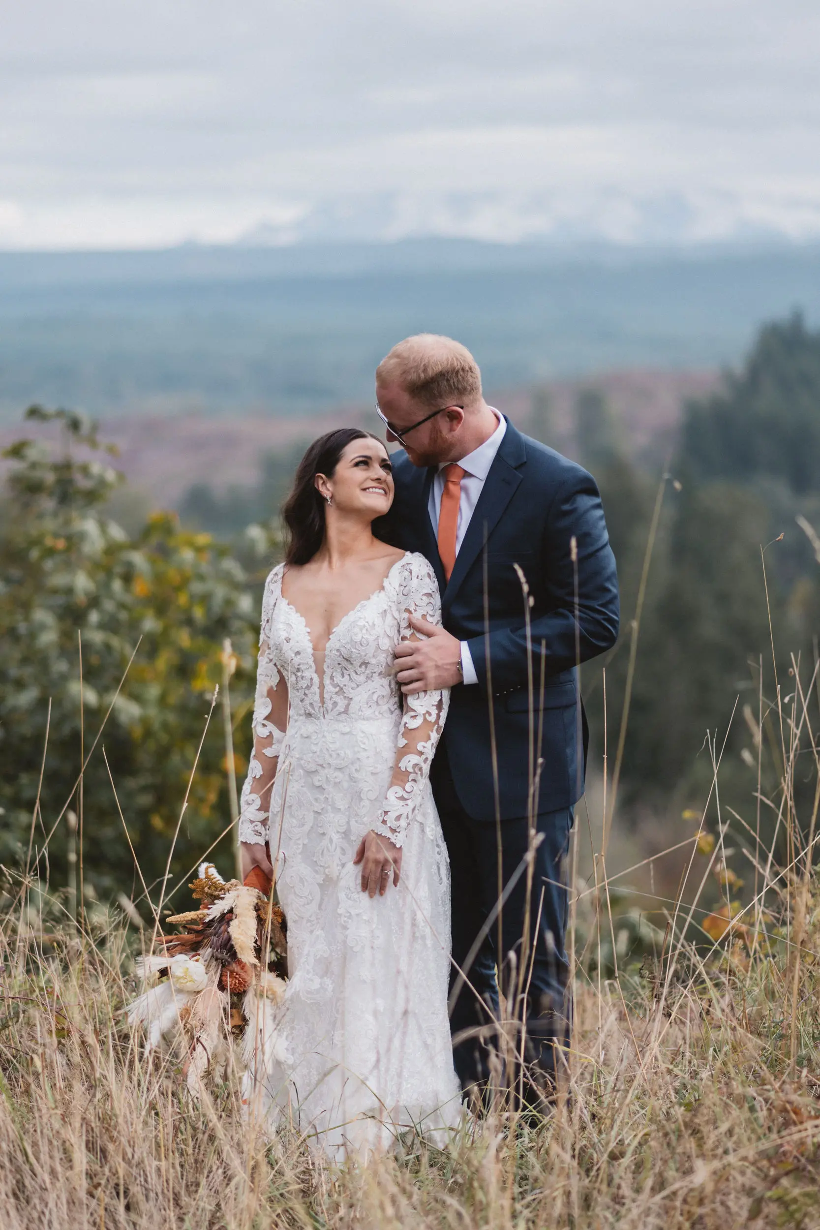 Bride Wearing Lace A-Line Wedding Dress Called Tuscany Lane By Maggie Sottero With Groom In the Mountains