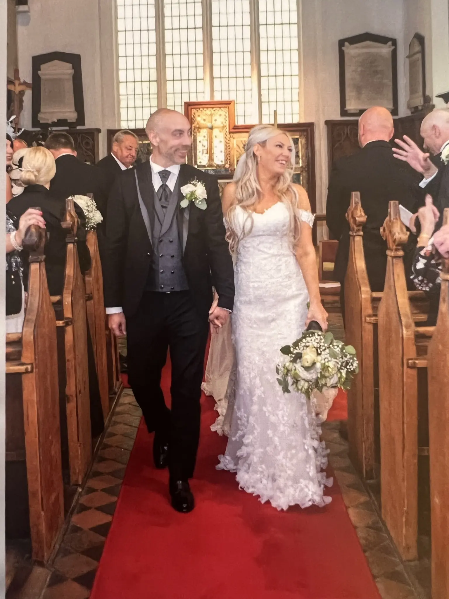 Bride And Groom Walking Down The Aisle. Bride Wearing Fit And Flare Lace Wedding Dress With 3D Floral Details Called Ryker By Sottero And Midgley
