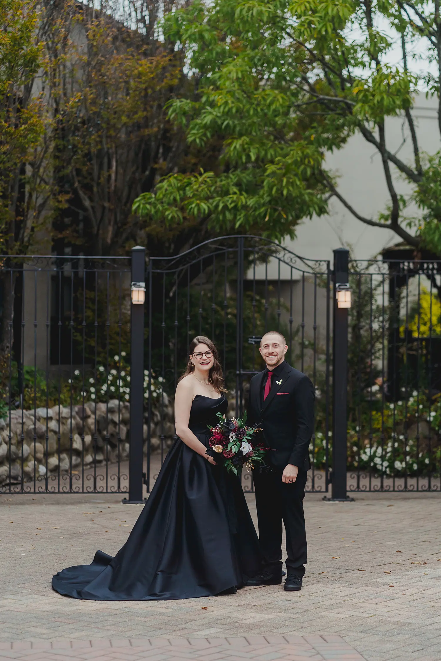 Bride wearing Aspen wedding dress by Sottero and Midgley standing with her husband