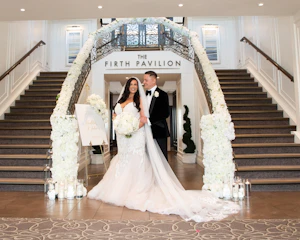 Bride in fit-and-flare wedding dress called Alistaire by Maggie Sottero with groom