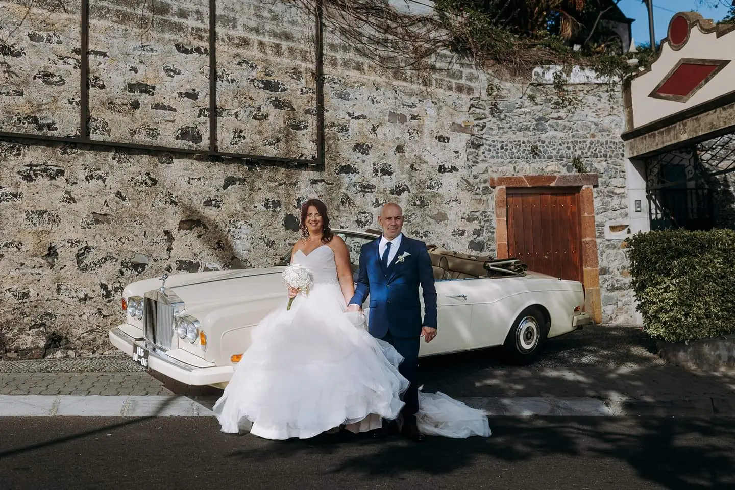 Bride Wearing Sparkly Ballgown Wedding Dress Called Yasmin By Maggie Sottero With Groom Next To A Convertible