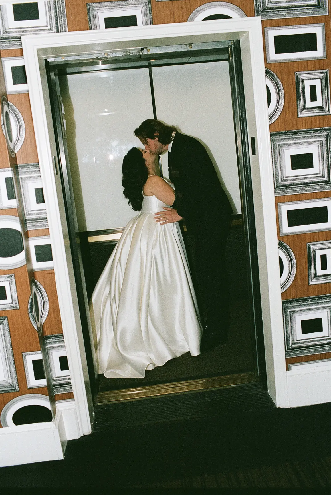 Bride Wearing Simple Aline Wedding Dress Called Selena By Maggie Sottero Kissing Groom In An Elevator