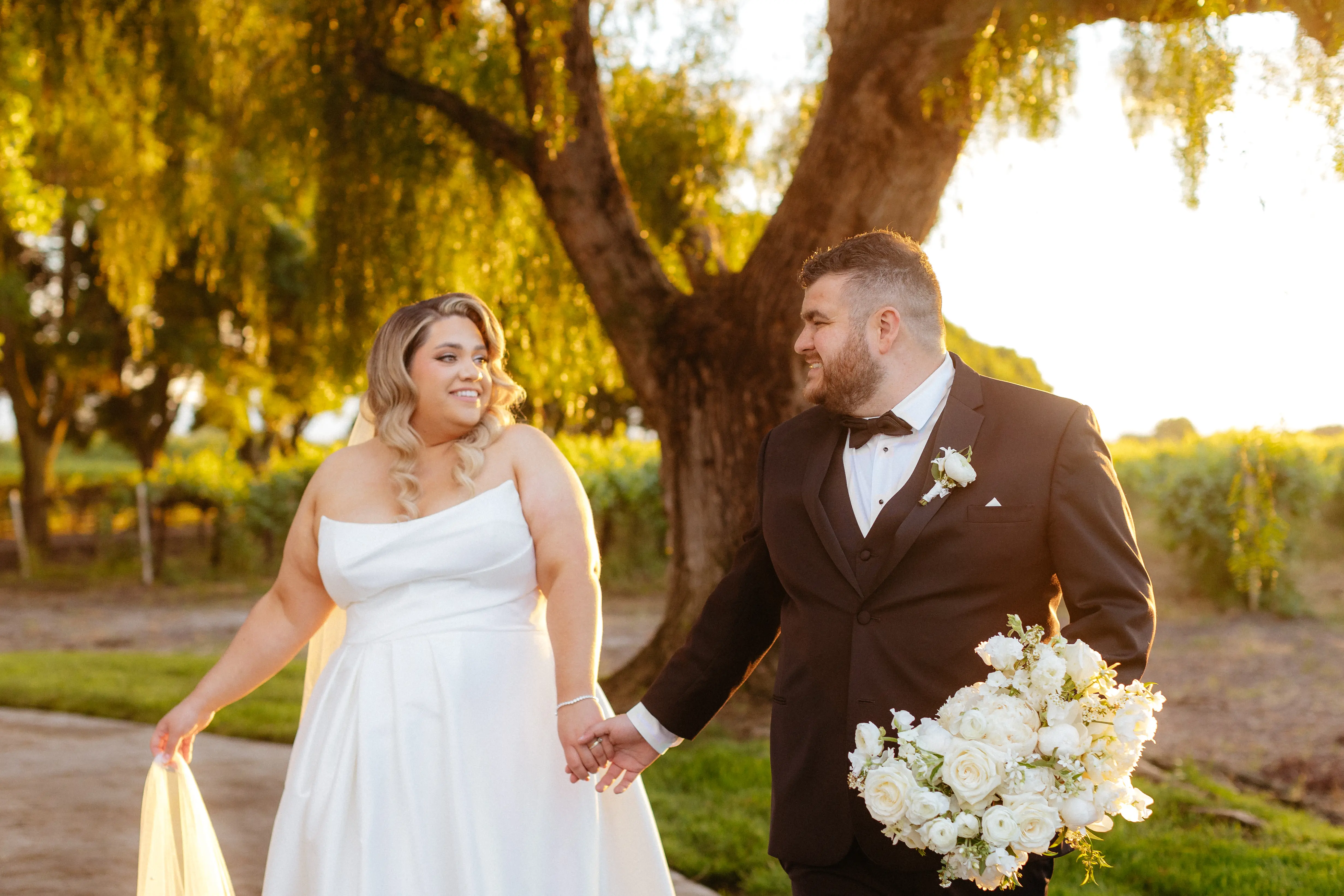 Bride wearing Aspen by Sottero and Midgley holding hands with her husband