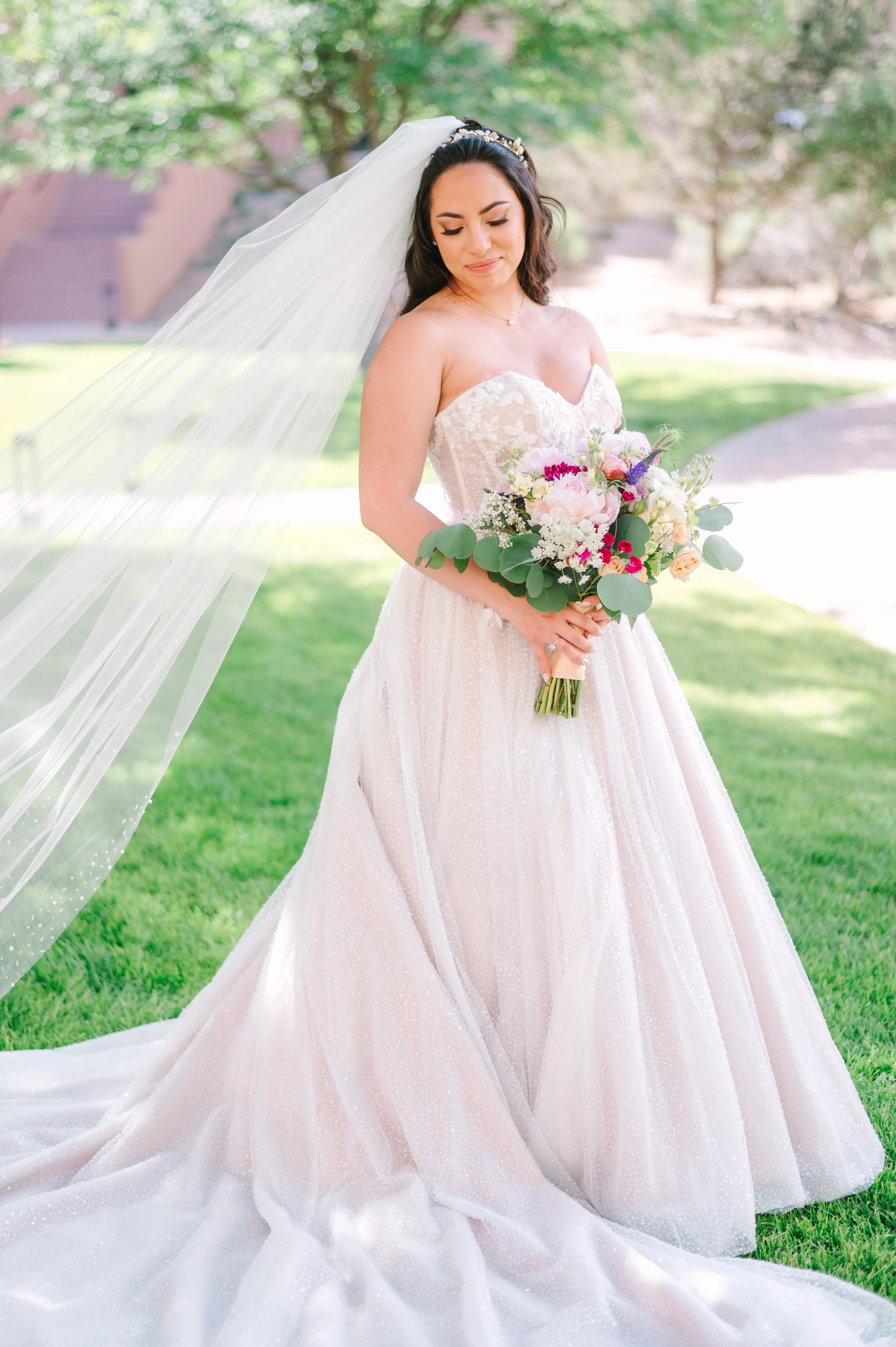 Bride In White Wedding Dress Named Shasta By Sottero and Midgley With Veil And Pink Flowers