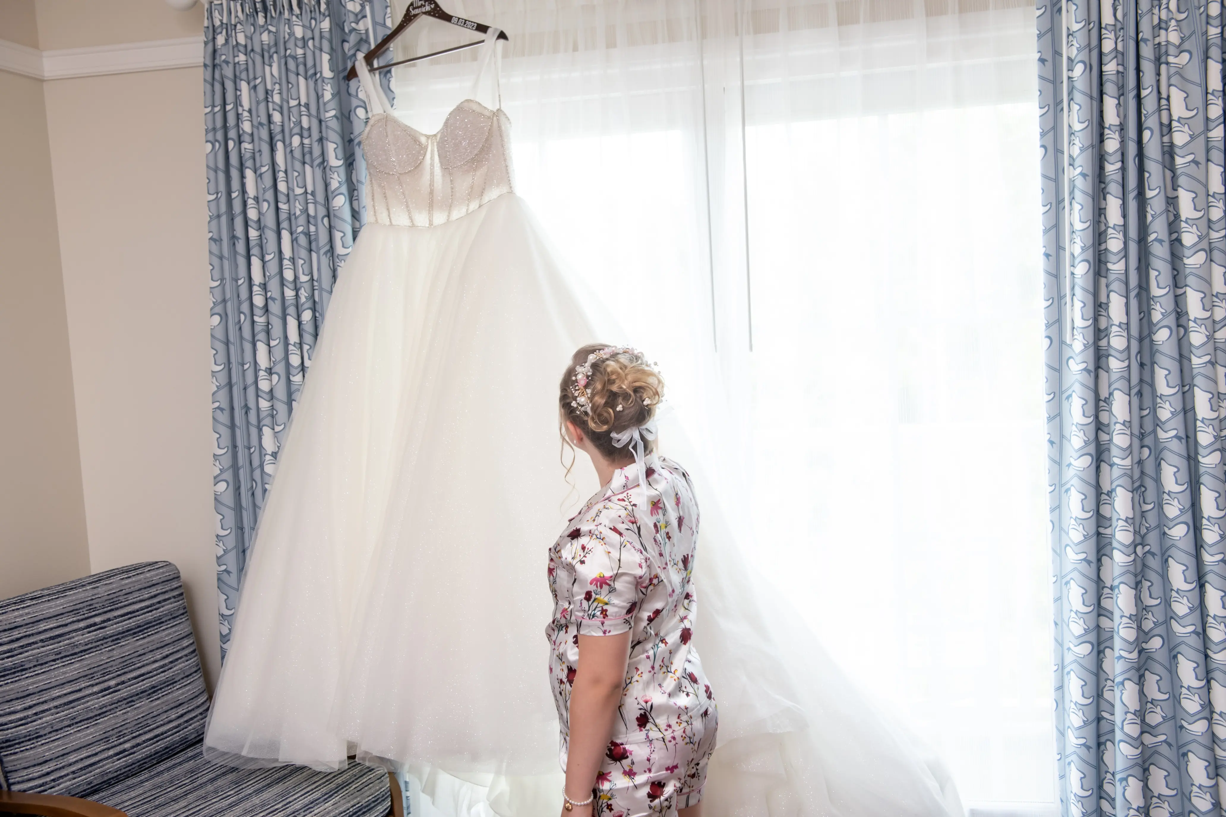 Bride looking at Elton wedding dress by Sottero and Midgley