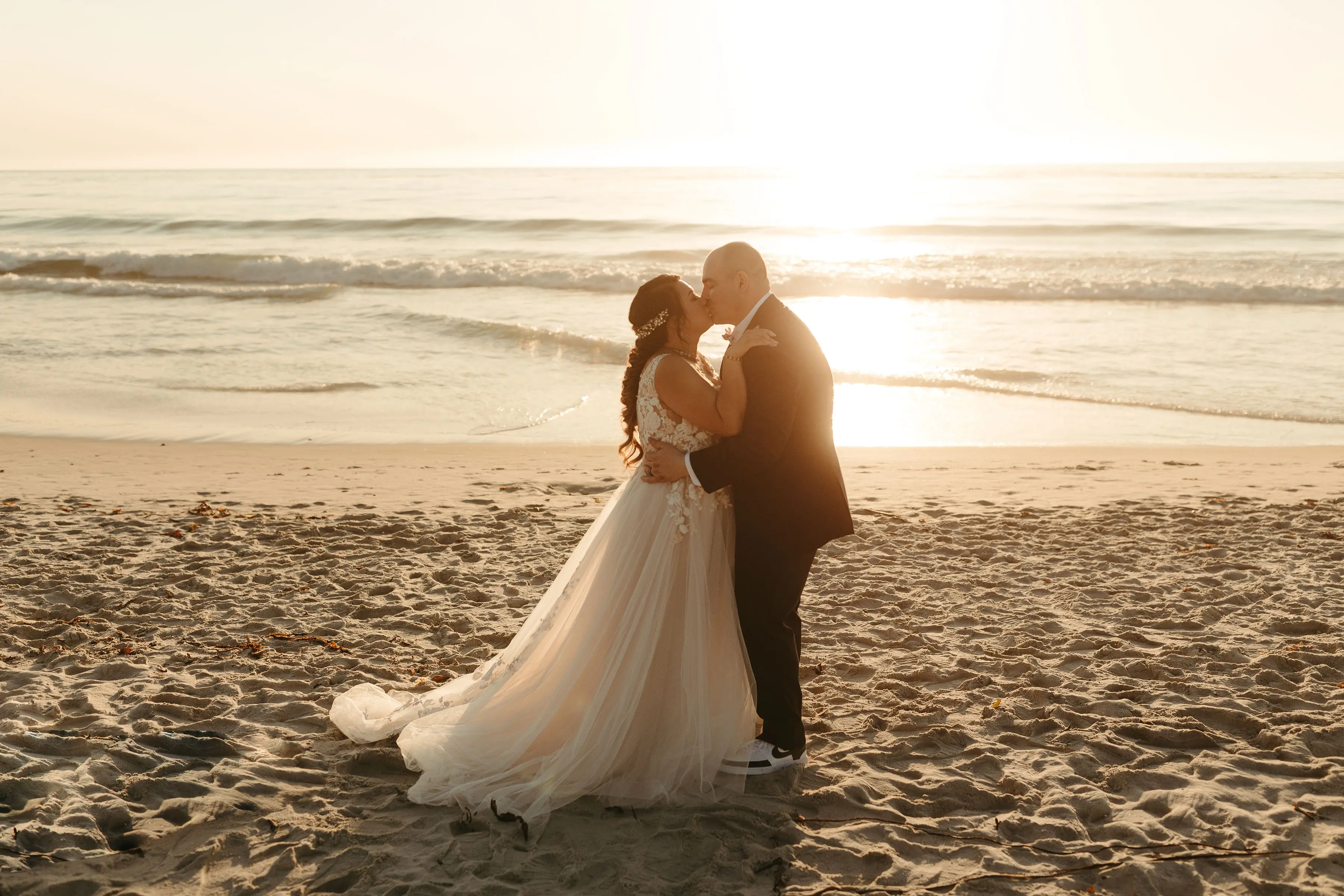 Bride with groom wearing affordable A-Line floral motif wedding dress.