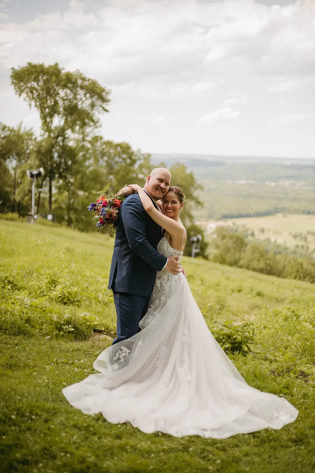 Bride In Floral Lace Bridal Gown Named Lettie By Rebecca Ingram Bride and Groom Hugging