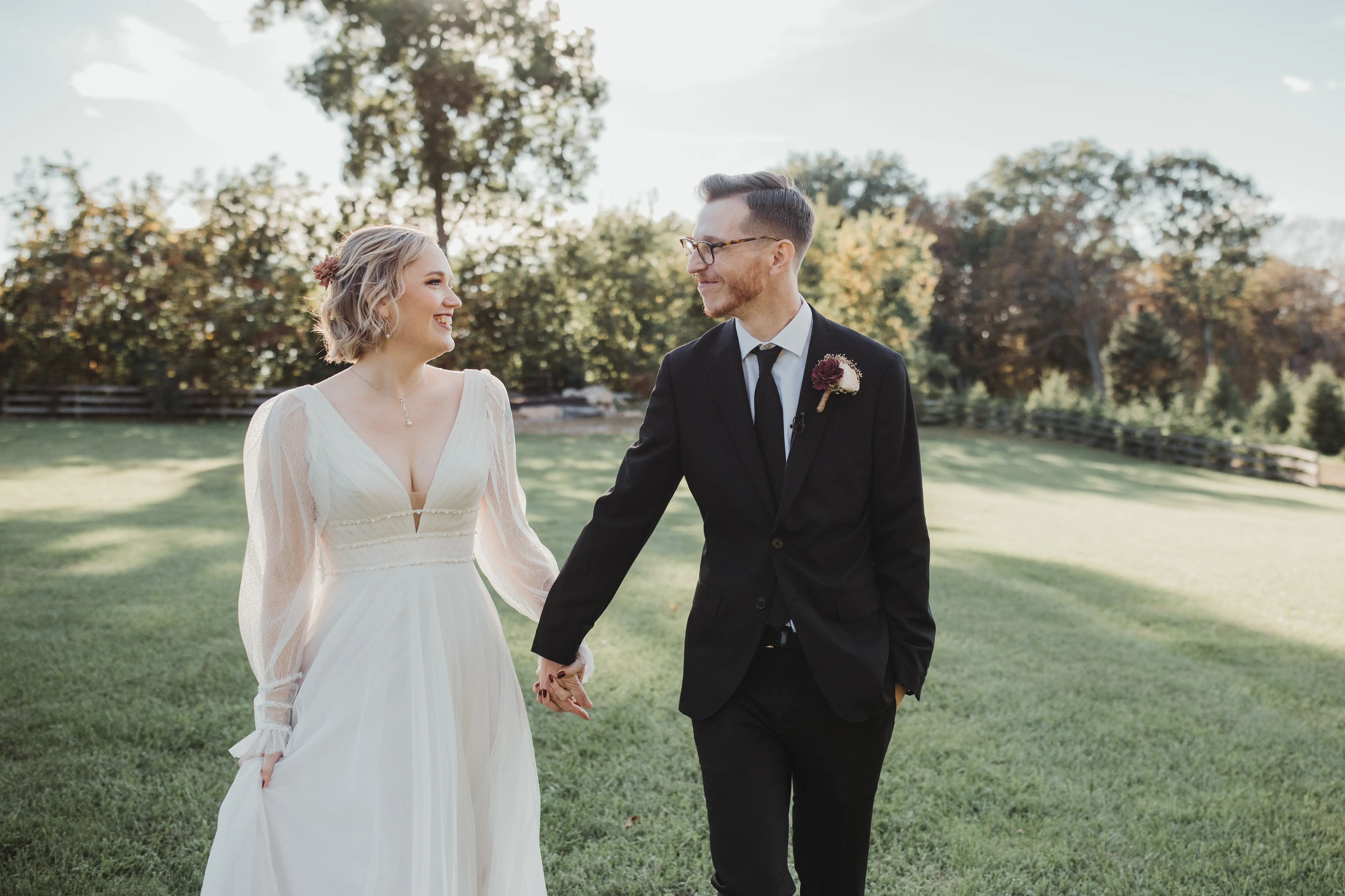 Bride Wearing Long-Sleeve A-Line Wedding Dress Called Joanne By Rebecca Ingram Holding Hands With Groom