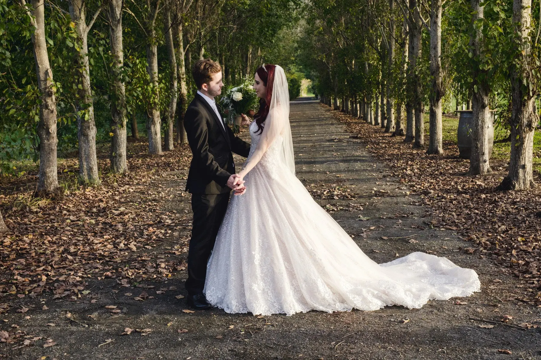 Groom with Bride in Lace Ball Gown Wedding Dress with Sequined Tulle and Lace Motifs over Bodice and Statement Hemline called Tristyn by Maggie Sottero