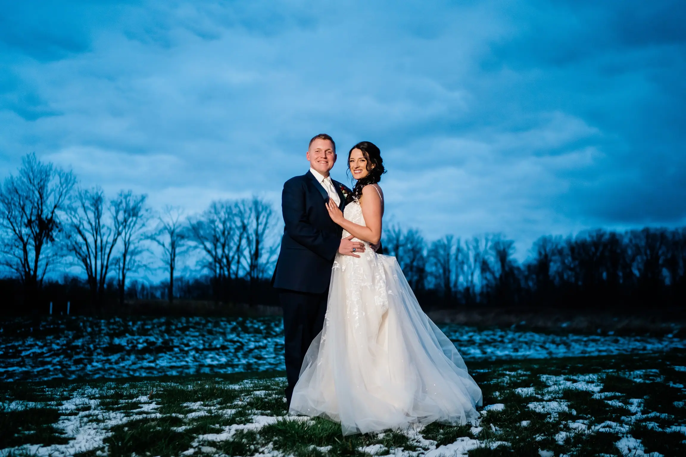 Bride Wearing Ballerina-inspired Romantic Wedding Dress Called Fairbanks By Maggie Sottero In A Snowy Field With Groom