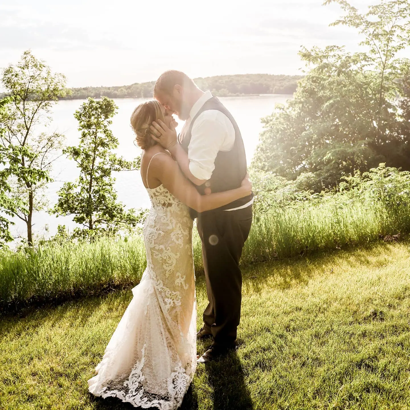 Bride with groom wearing romantic lace sheath wedding dress
